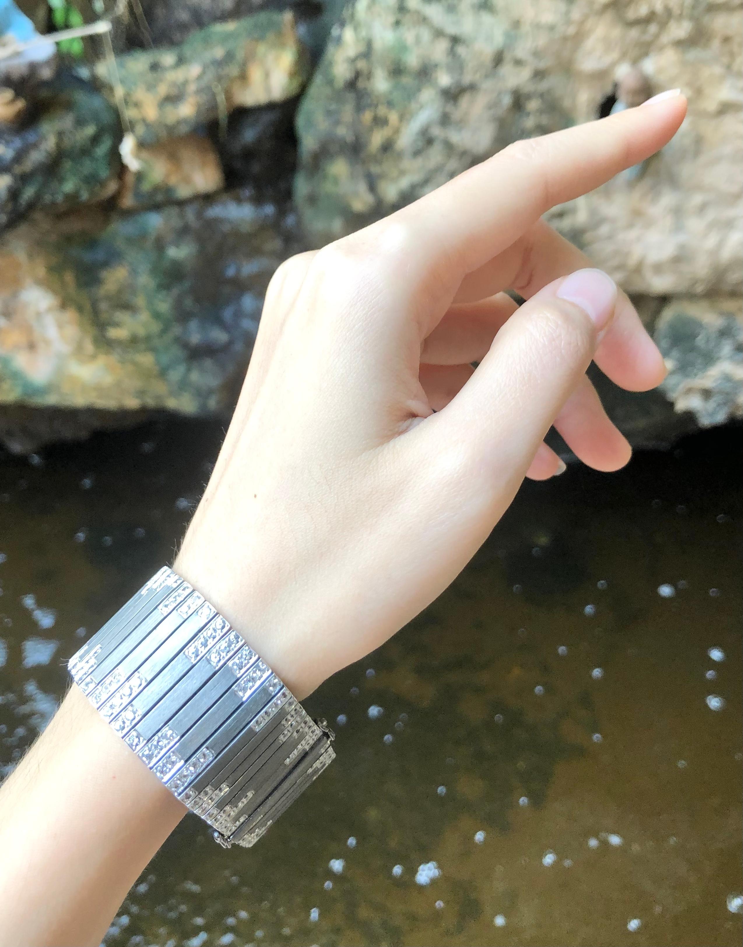 White Sapphire 10.10 carats Bracelet set in Silver Settings

Width:  2.8 cm 
Length: 18.6 cm
Total Weight: 73.47 grams

*Please note that the silver setting is plated with rhodium which helps prevent oxidation.  However, with the nature of silver,