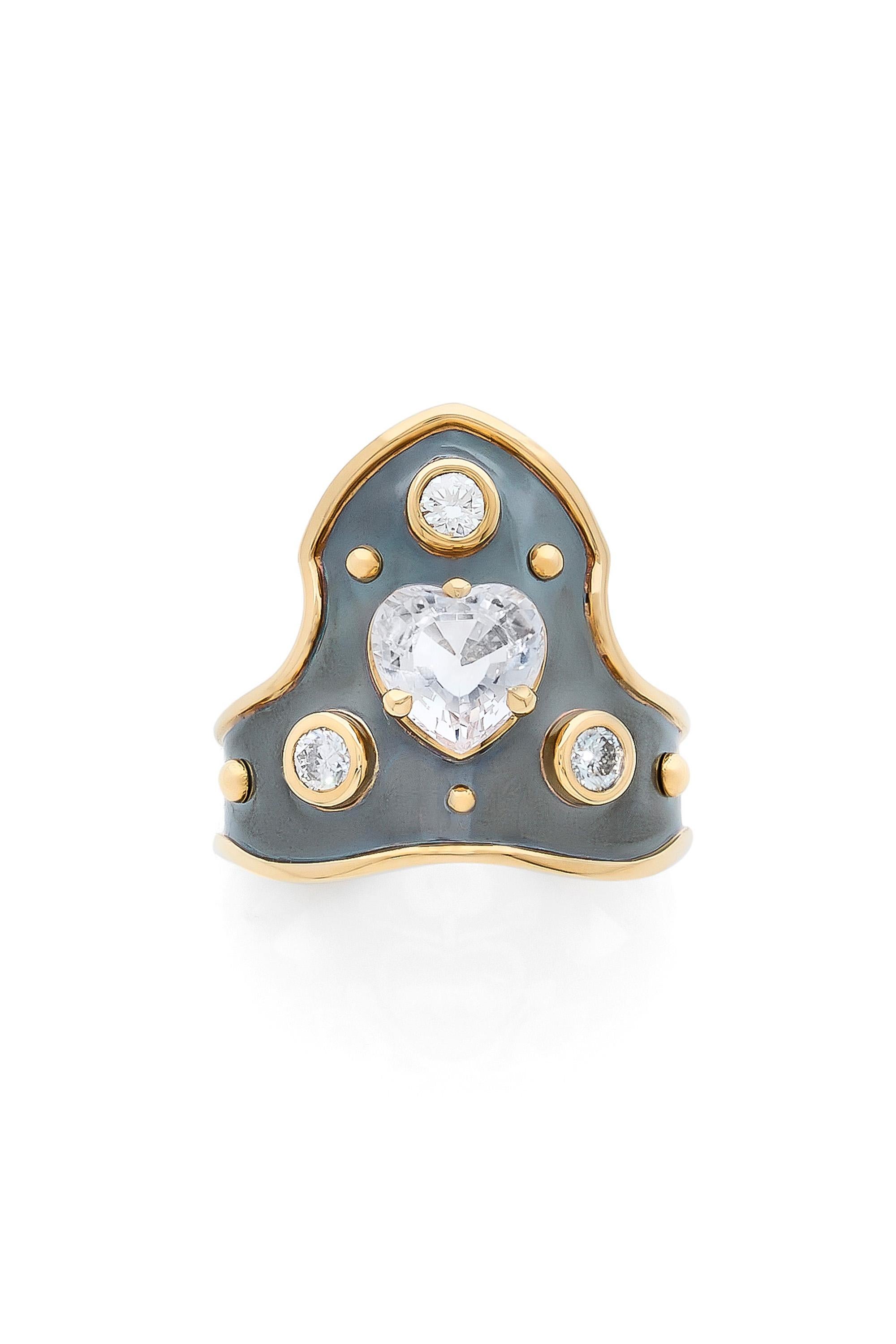 Yellow gold and distressed silver ring studded with a white sapphire heart surrounded by 3 diamonds.

Details:
White Sapphire Heart : 1.73 cts      
Diamonds : 0.3 cts 
18k Yellow Gold : 3.6 g 
Distressed Silver : 2.9 g
Made in France