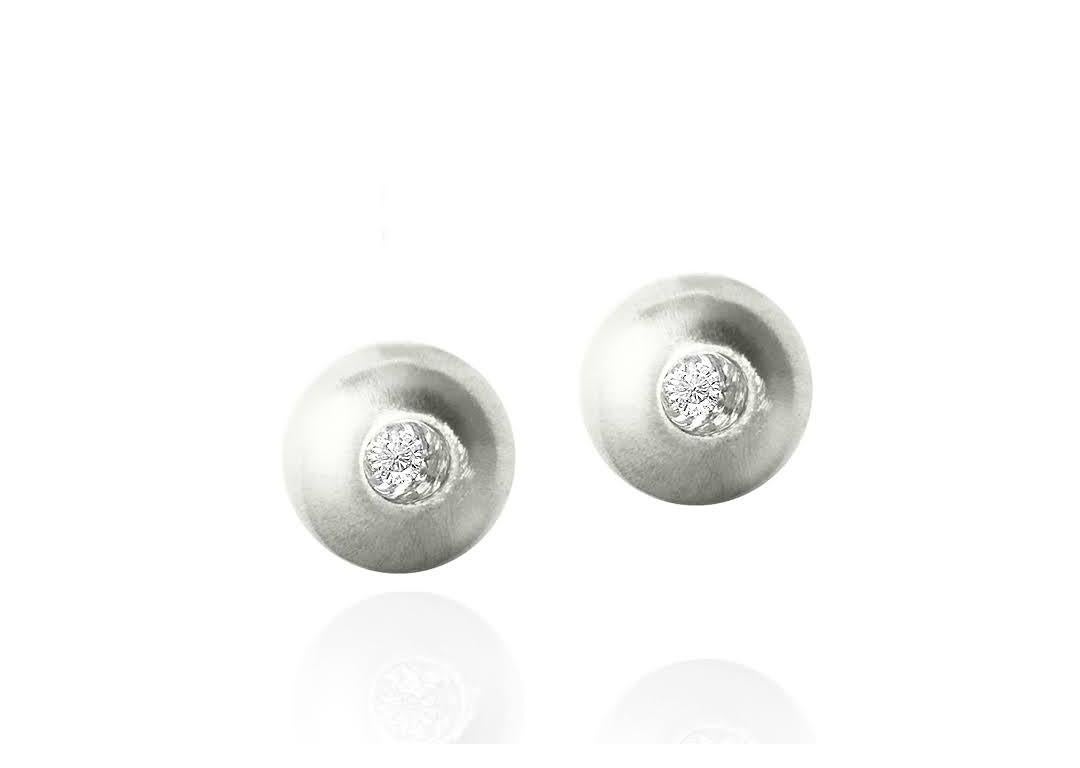 These White Sapphire in Silver Dome Stud Earrings, part of our Power Series, are a symbolic design inspired by the idea of looking inward, the notion of what a person needs is already inside of them. The clean and classic lines are imaginative,