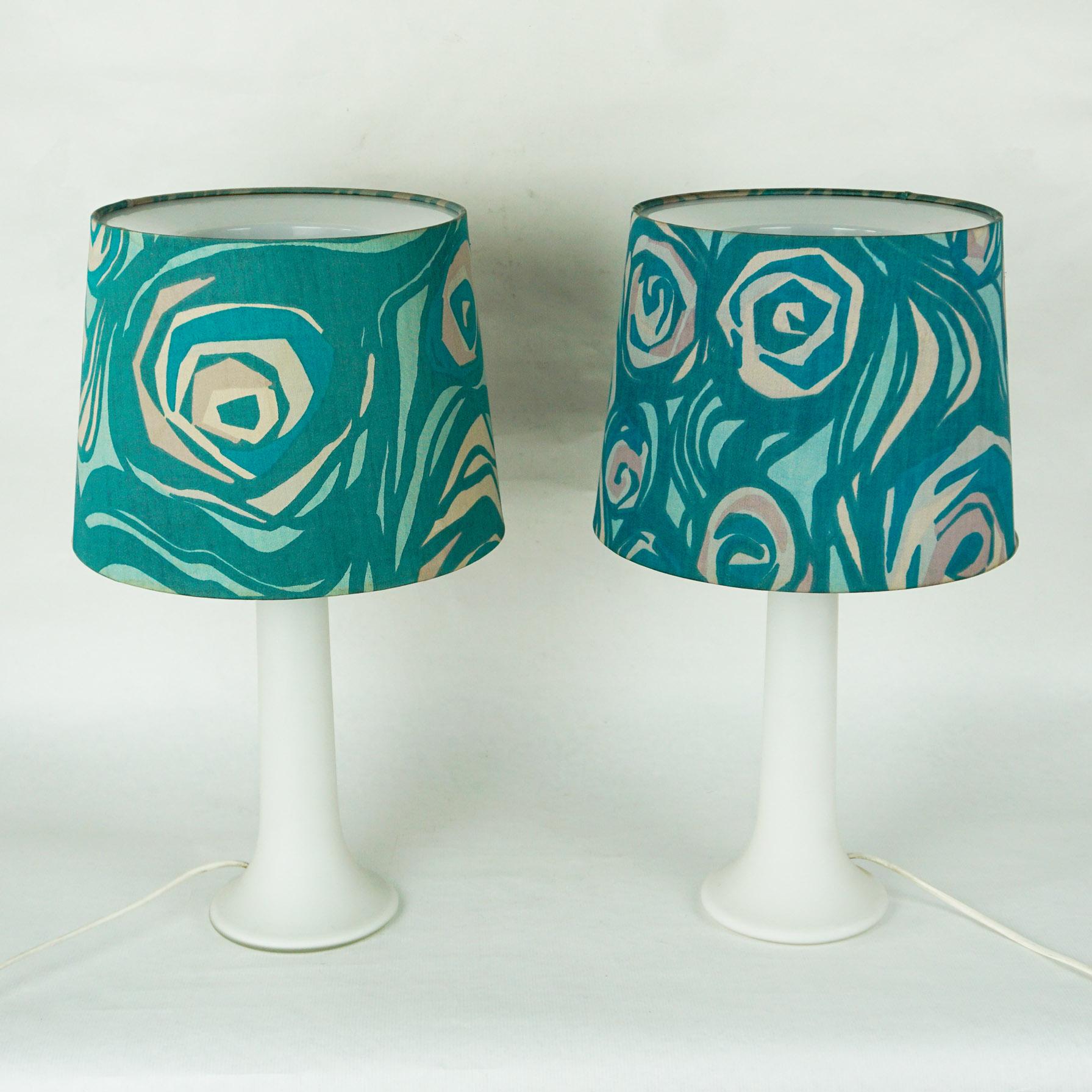 Very rare pair of 1960s glass table lamps with original blue floral fabric lampshades by Luxus Vittsjö, made in Sweden, designed by Uno and Osten Kristiansson. Beautiful high quality Scandinavian design. The bases are made of thick overlay white
