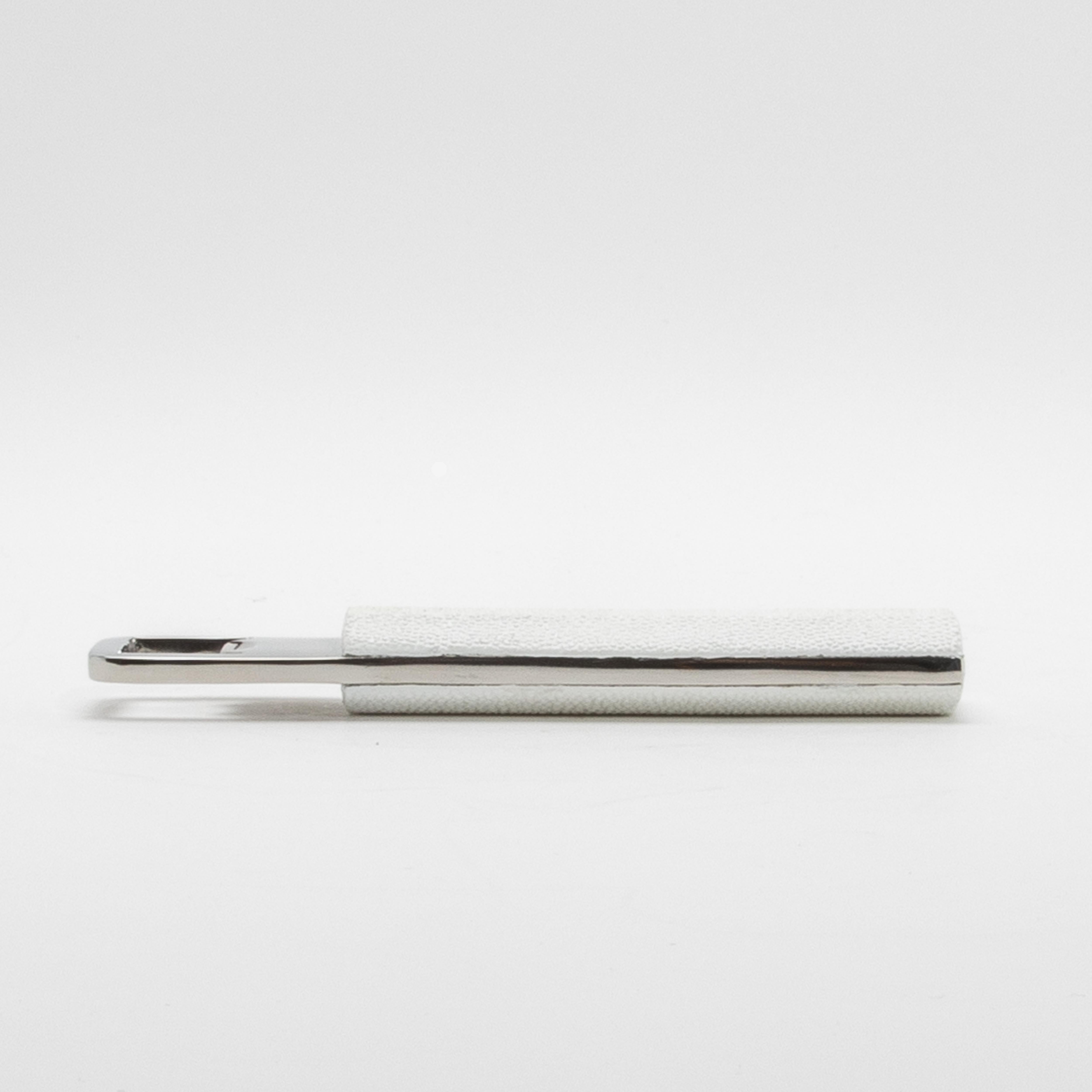 Transform everyday utility into a piece of art with this White Shagreen Bottle Opener by Kifu Paris. The soft white shagreen texture is both visually stunning and pleasing to the touch, while the gleaming stainless steel adds a modern, polished