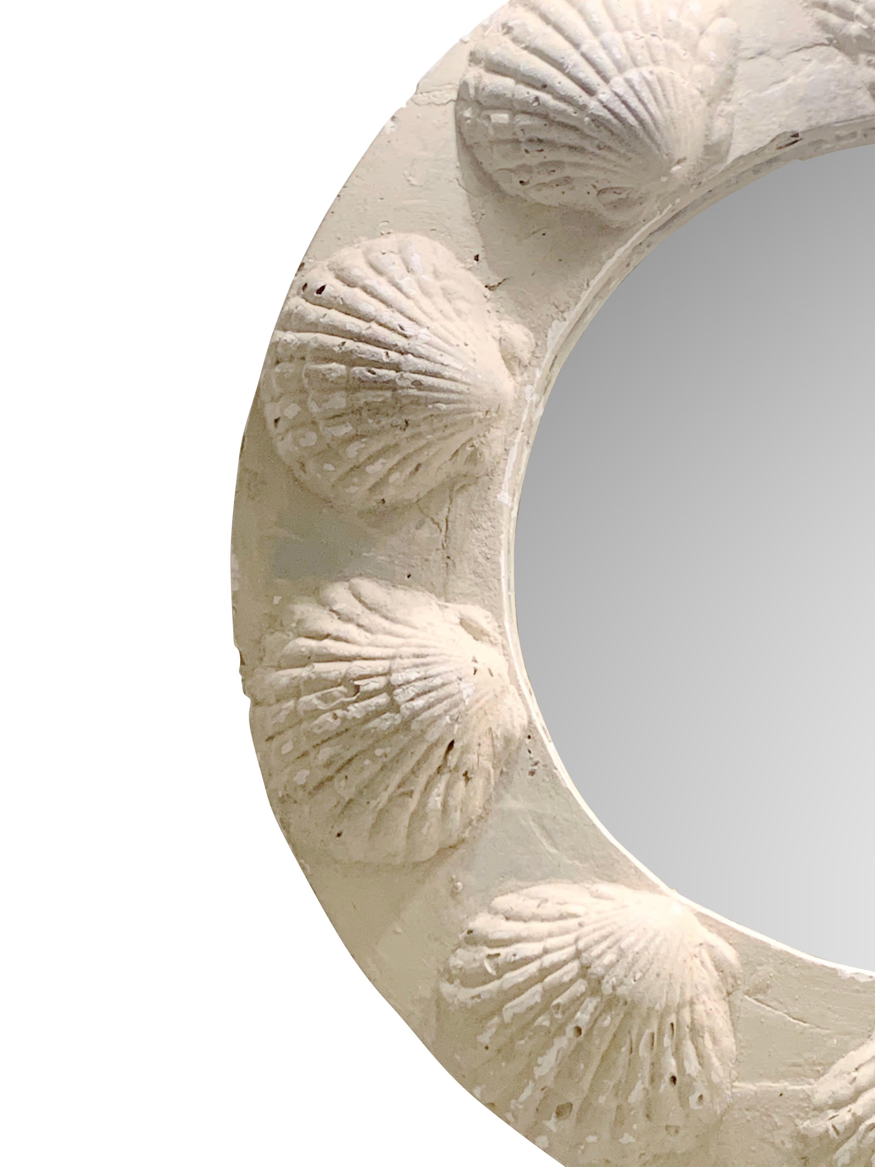 Midcentury French round plaster mirror with decorative shell motif frame.
Patina of shades of white.
Hangs from a decorative metal ring.
Mirror diameter 27