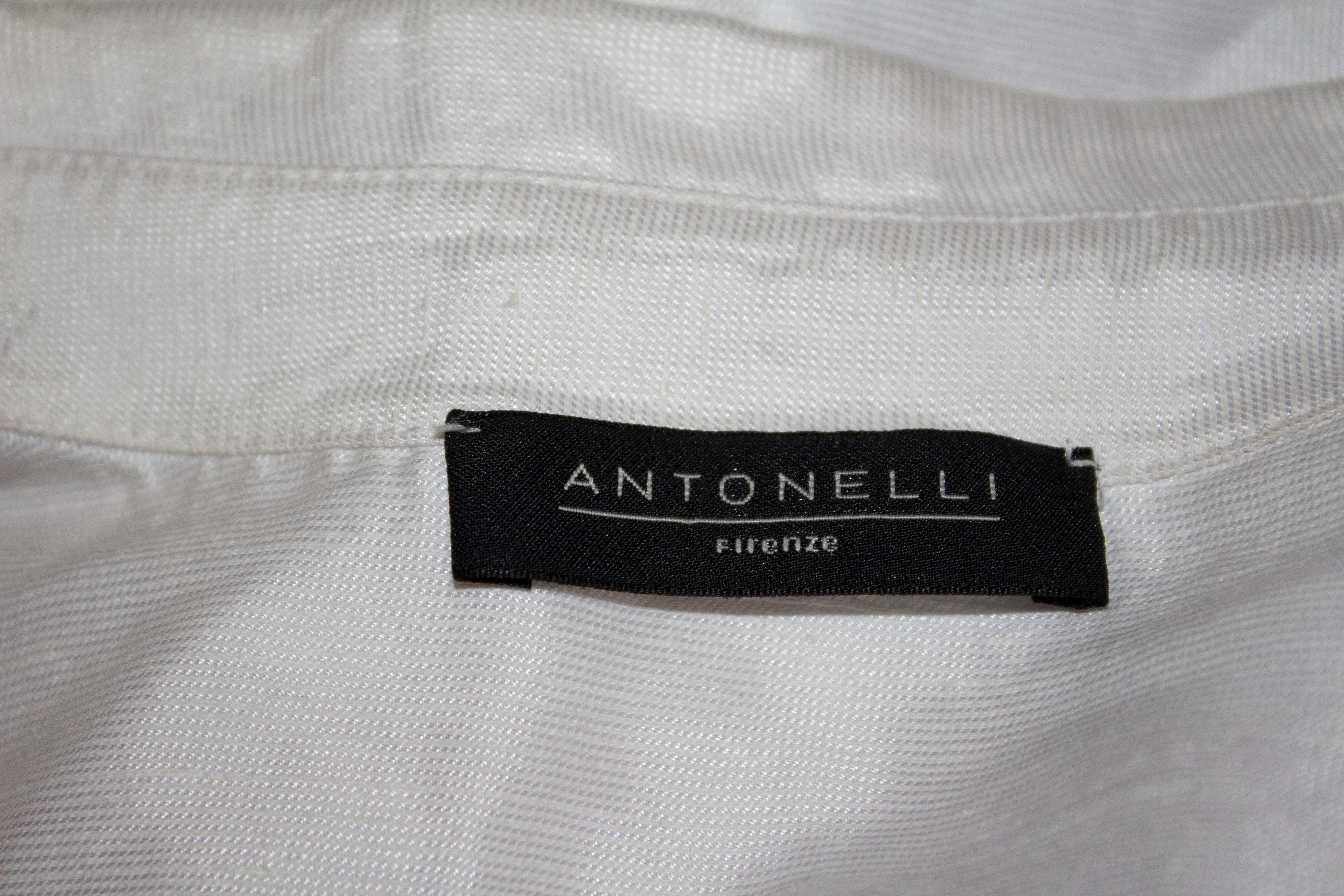 A fun and pretty white cotton mix ( linen, silk , viscose) shirt by Antonelli Firenze. The shirt has a collar and tie at the front. Size F38, UK10, measurements: Bust up to 39'', length 28''