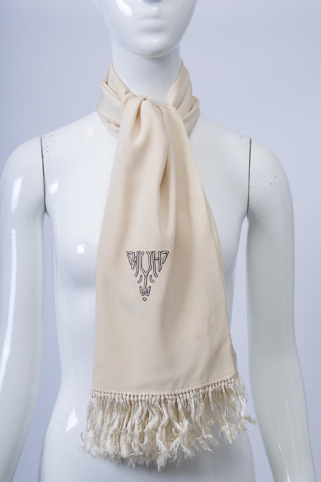 Vintage monogrammed men’s scarf traditionally worn for evening. Silk with fringed edges monogram reads “H/M”.