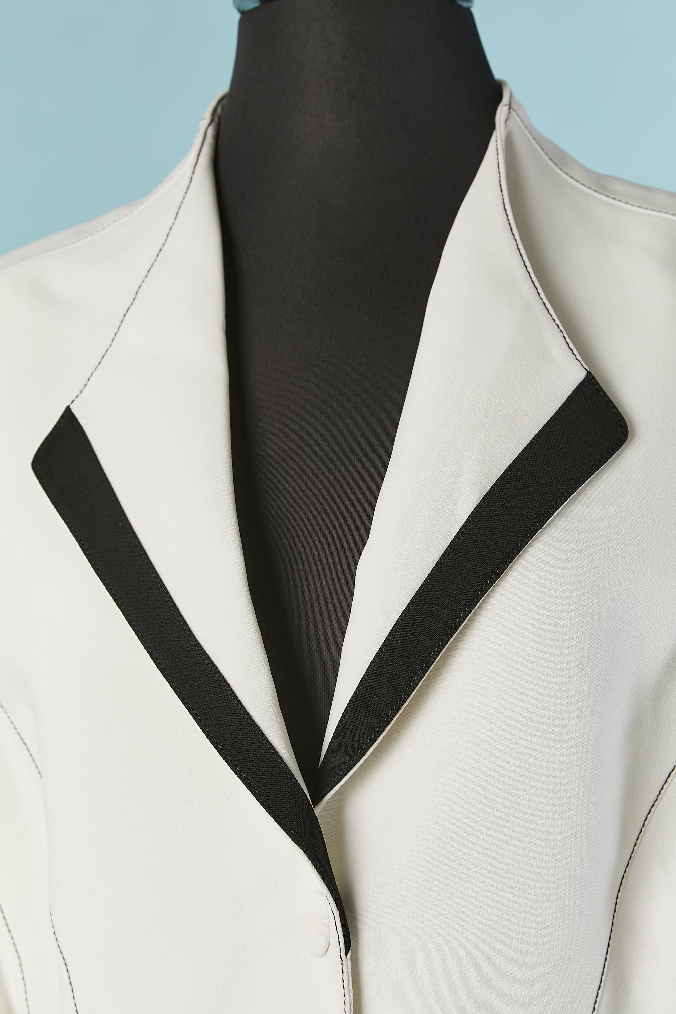 White single-breasted jacket with black edge. Main fabric: 100% polyester. No fabric composition tag for the lining but probably polyester, rayon or acetate. 
Snap closure in the middle front. Split on the side front 
SIZE 44 (Fr)  L 