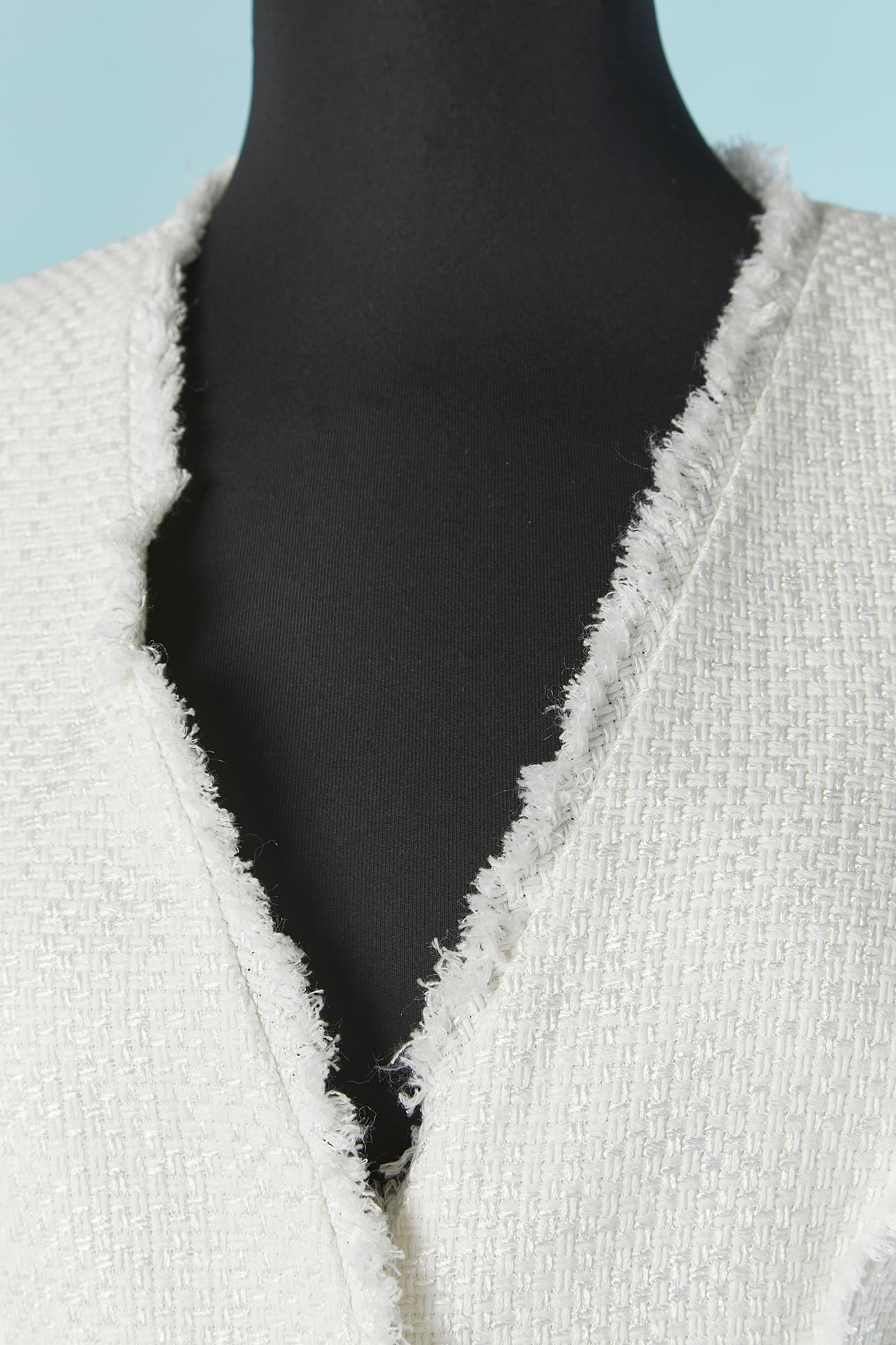 White skirt-suit with fringes raw edge. Fabric composition: 42% cotton, 26% rayon, 24% silk, 8% nylon. 
Lining composition: 100% silk. 
Snap closure middle front. Cut-work. Shoulder pad. Authenticity hologram. 
SIZE 40 (It) 36 (Fr) S 