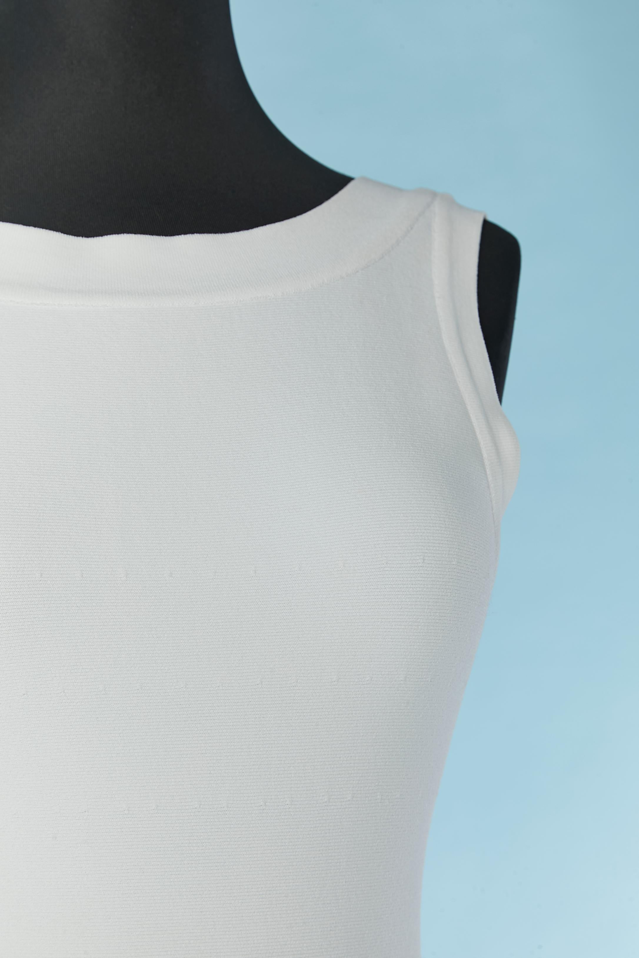 White sleeveless cocktail dress with see-through lines on the skirt and underskirt. 
Fabric composition: 78% rayon, 19% polyester, 2% polyamide, 1% elastane. 
Zip closure on the middle back on the dress. no closure on the underskirt. 
SIZE 36/S