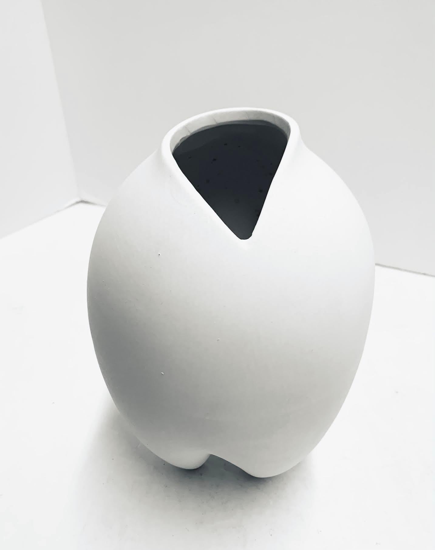 Contemporary Danish designed bone white slim vase.
Three pointed V shaped base.
Part of a very large collection.