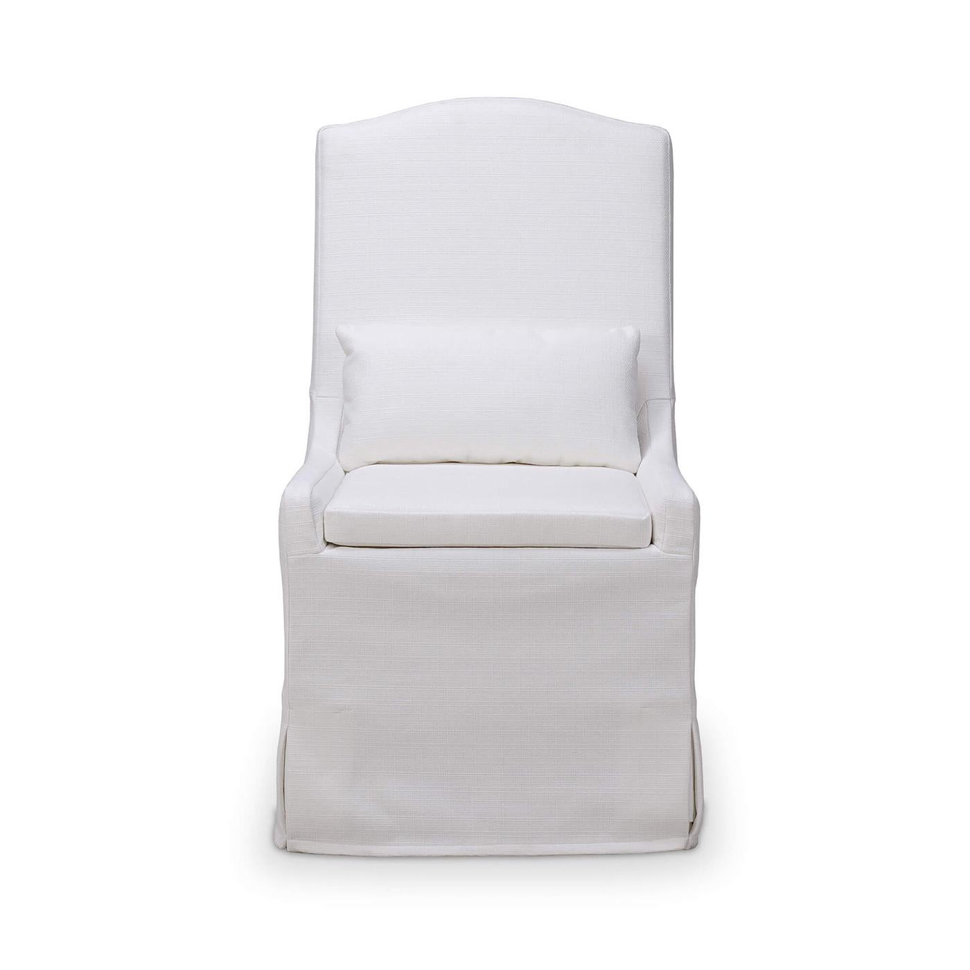 A seamless blend of elegance and practicality. Upholstered in premium Arctic White performance fabric, this chair, raised on casters, combines timeless design with easy maintenance.  

The slip-covered design adds a touch of casual charm, making it