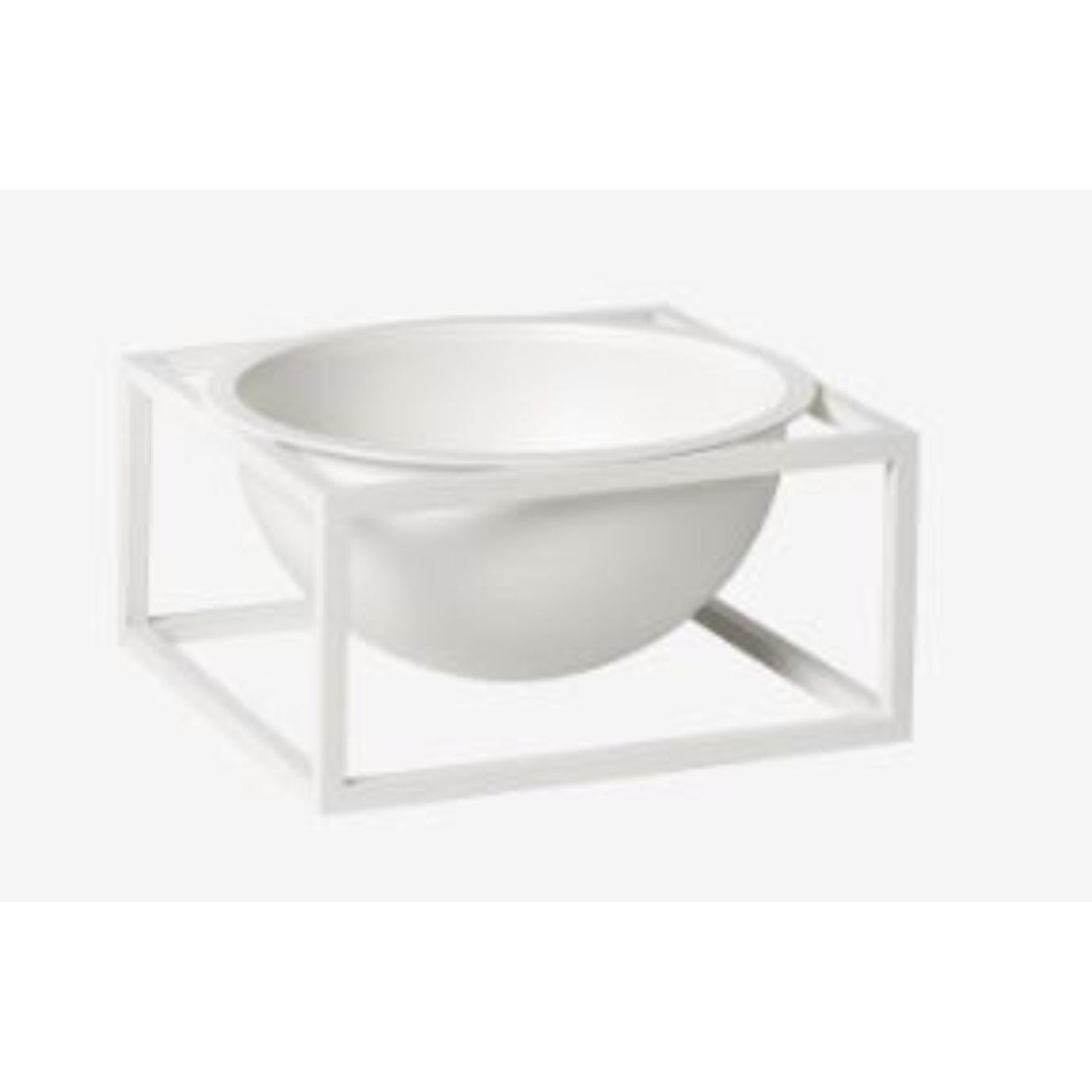 White small centerpiece Kubus bowl by Lassen
Dimensions: D 14 x W 14 x H 7 cm 
Materials: Metal 
Weight: 1.35 Kg

The dictionary definition is “an object occupying a central, especially an adornment in the center of a table” and the Kubus
