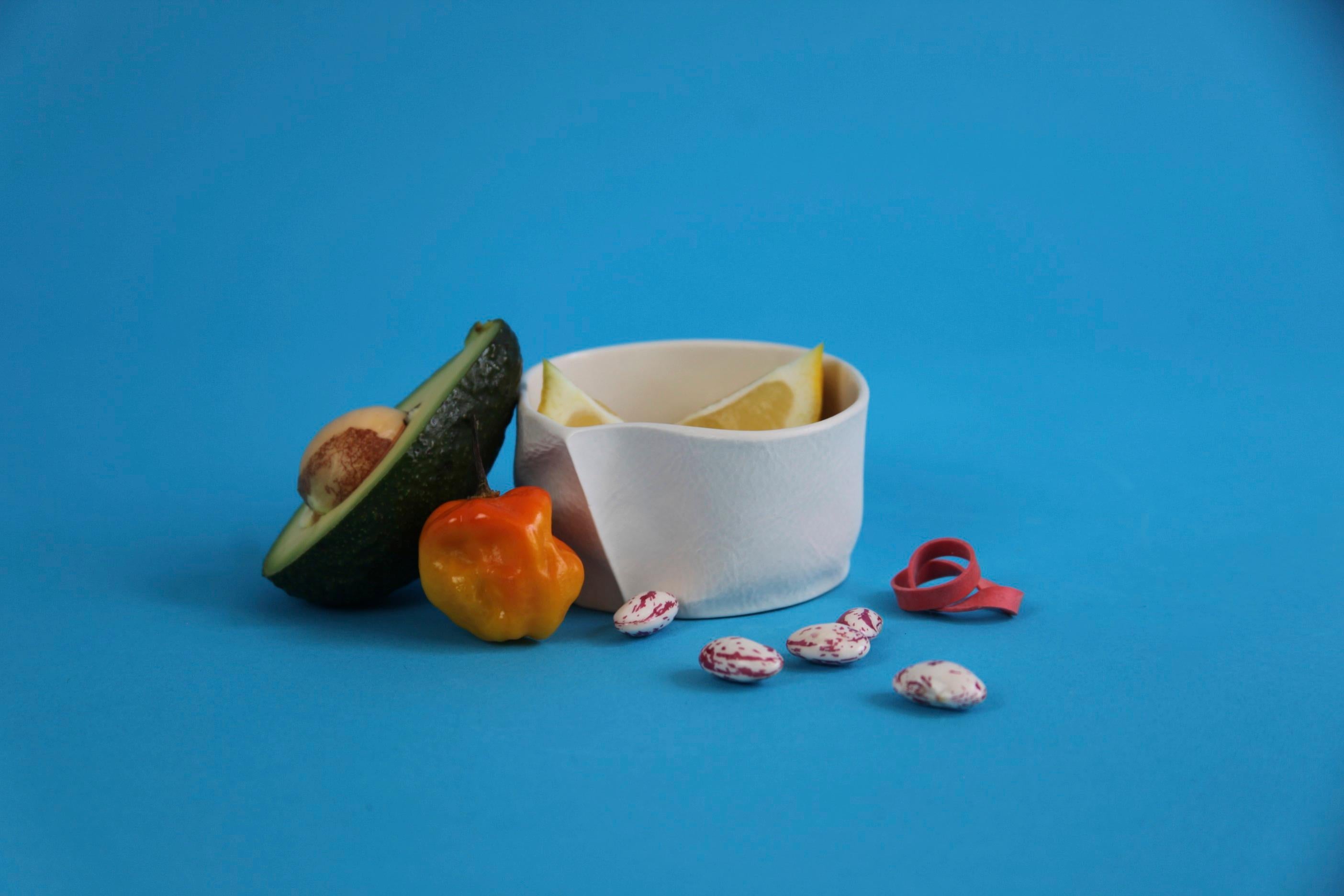 An organic shaped porcelain bowl with a tactile exterior surface and smooth glazed interior. Small & precious, yet surprisingly practical, the Kawa Dishes are equally well-suited as a jewelry dish, salt cellar, sauces & dips bowl. As a result of the