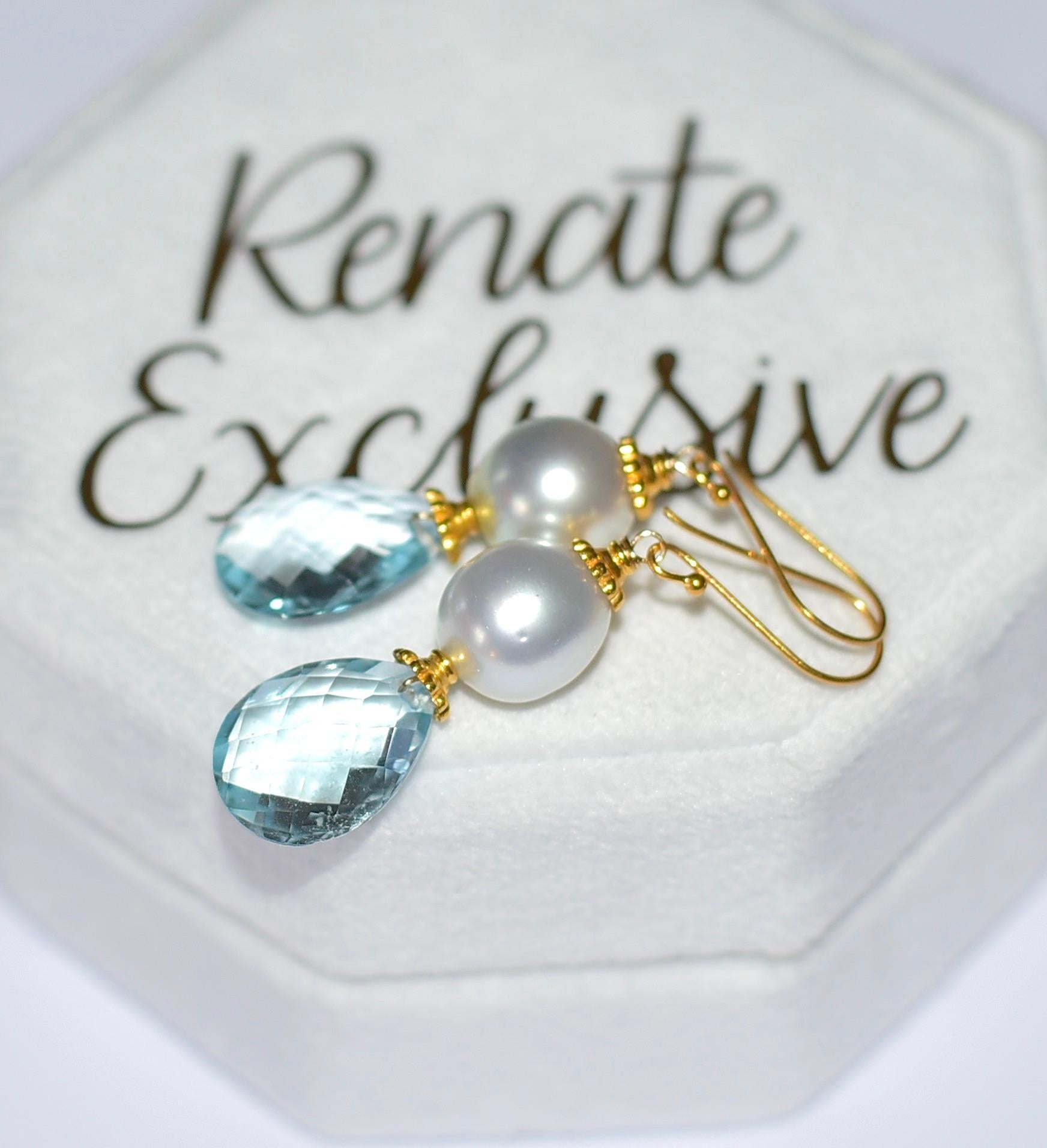 If you like pearls, then this simple, shiny, and beautiful piece of jewelry are for you!
White South Sea Cultured Pearl (10,5mm x 11,5mm ) and Blue Topaz Faceted Briolette (12mm x 16mm ) with 18K Solid Yellow Gold. Sounds lovely? Yes, it is! 
18k