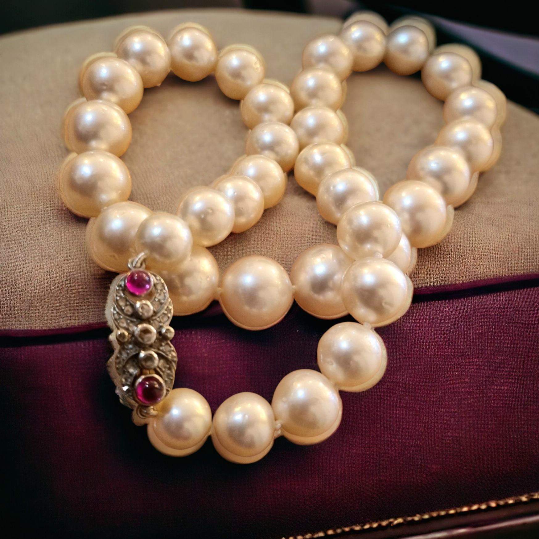 Graduated South Sea Pearl Necklace. Thirty-five high luster, white south sea pearls with shimmering overtones of silver and rose, compose this 19 -1/2 inch knotted necklace. The pearls  round shaped and well matched,  graduate from approximately 10
