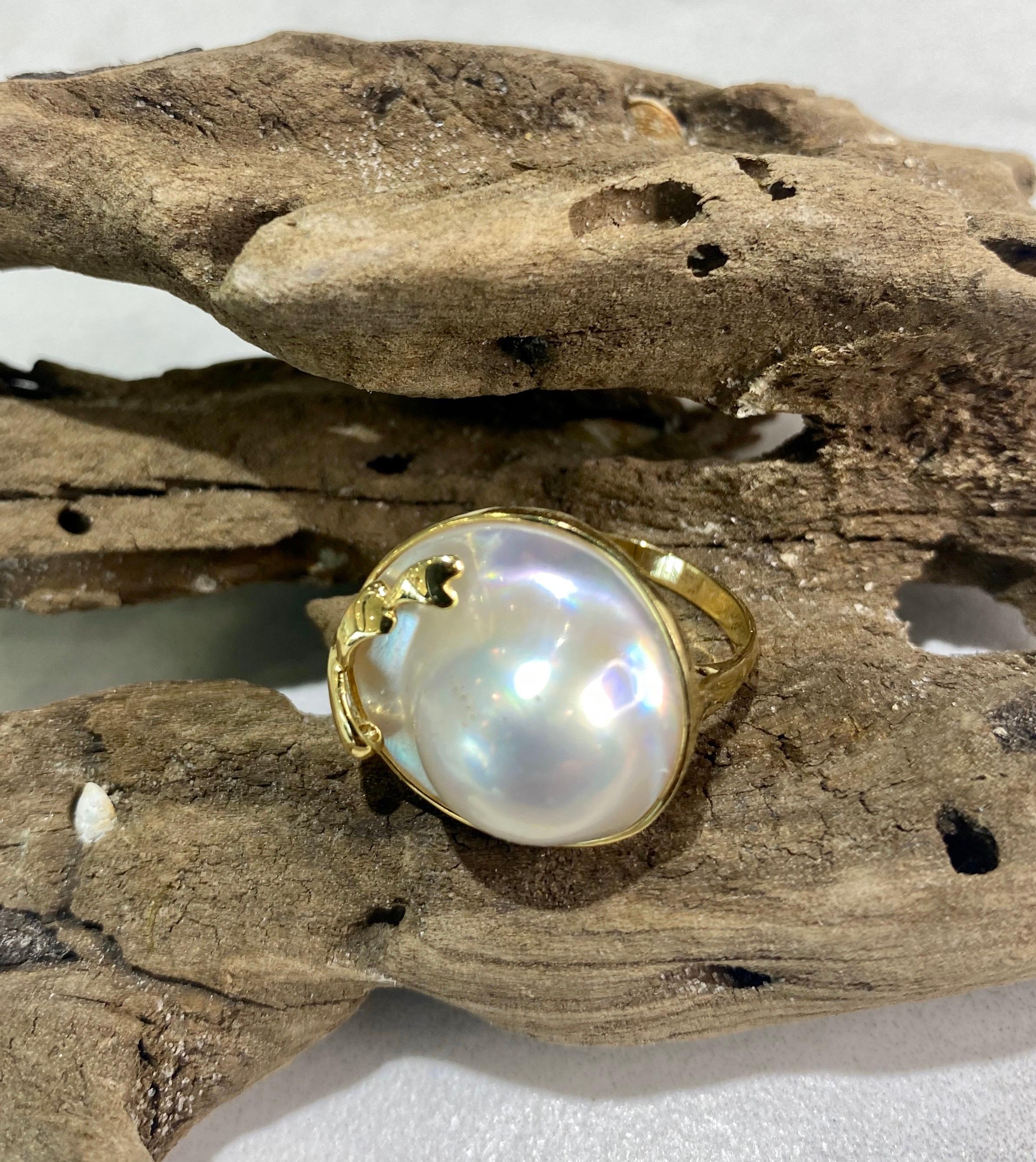 This stunning ring is made with a large 16mm South Sea mabe pearl with a mirror-like luster, set in 14k gold.  The setting was handcrafted to showcase the beauty of the pearl.  The ring is size 7 and can easily be resized if needed.