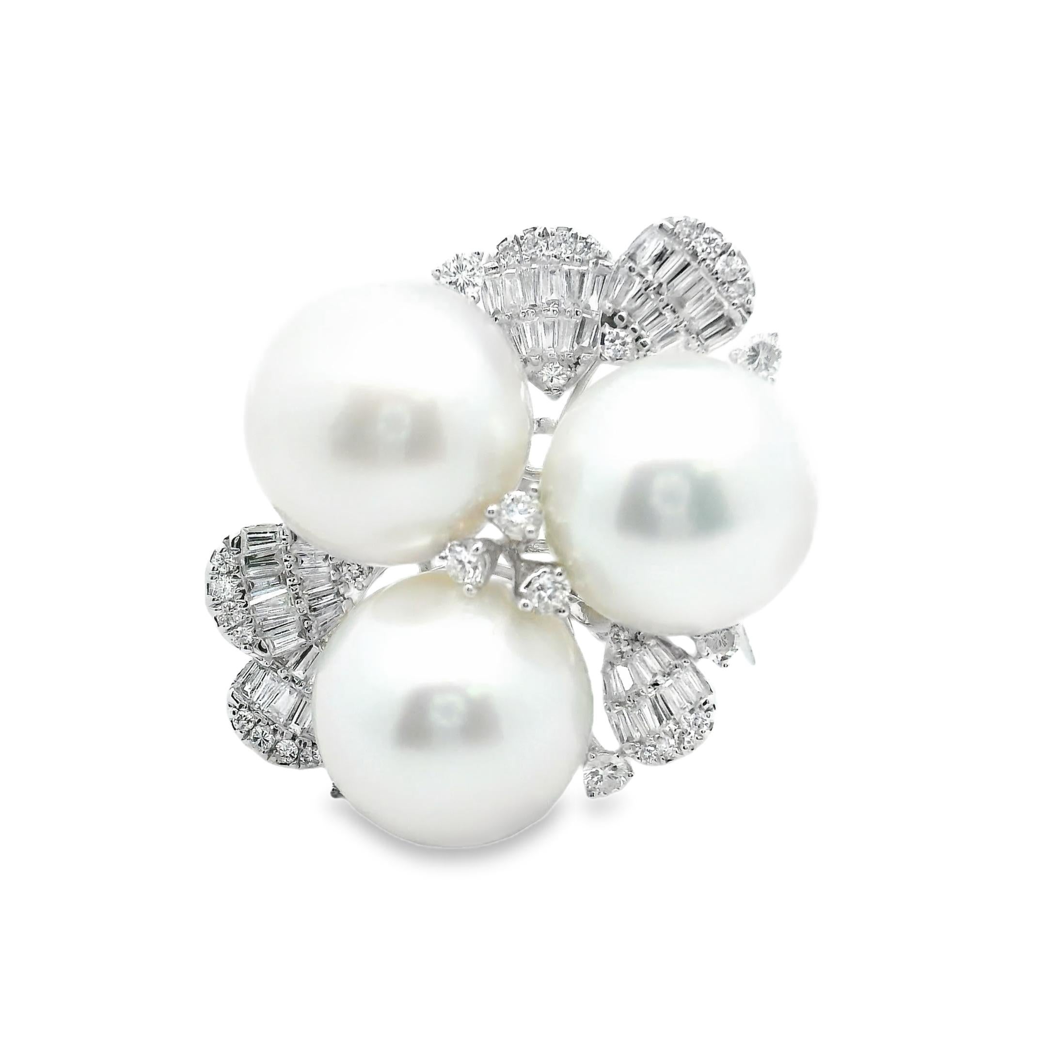 An absolutely irresistible South Sea Pearl and Diamond Ring. This fabulous Ring is a true statement, a rare ensemble of three fine white South Sea pearls, each measuring a whopping 13.0mm, very high-quality and blemish-free pearls, embedded between