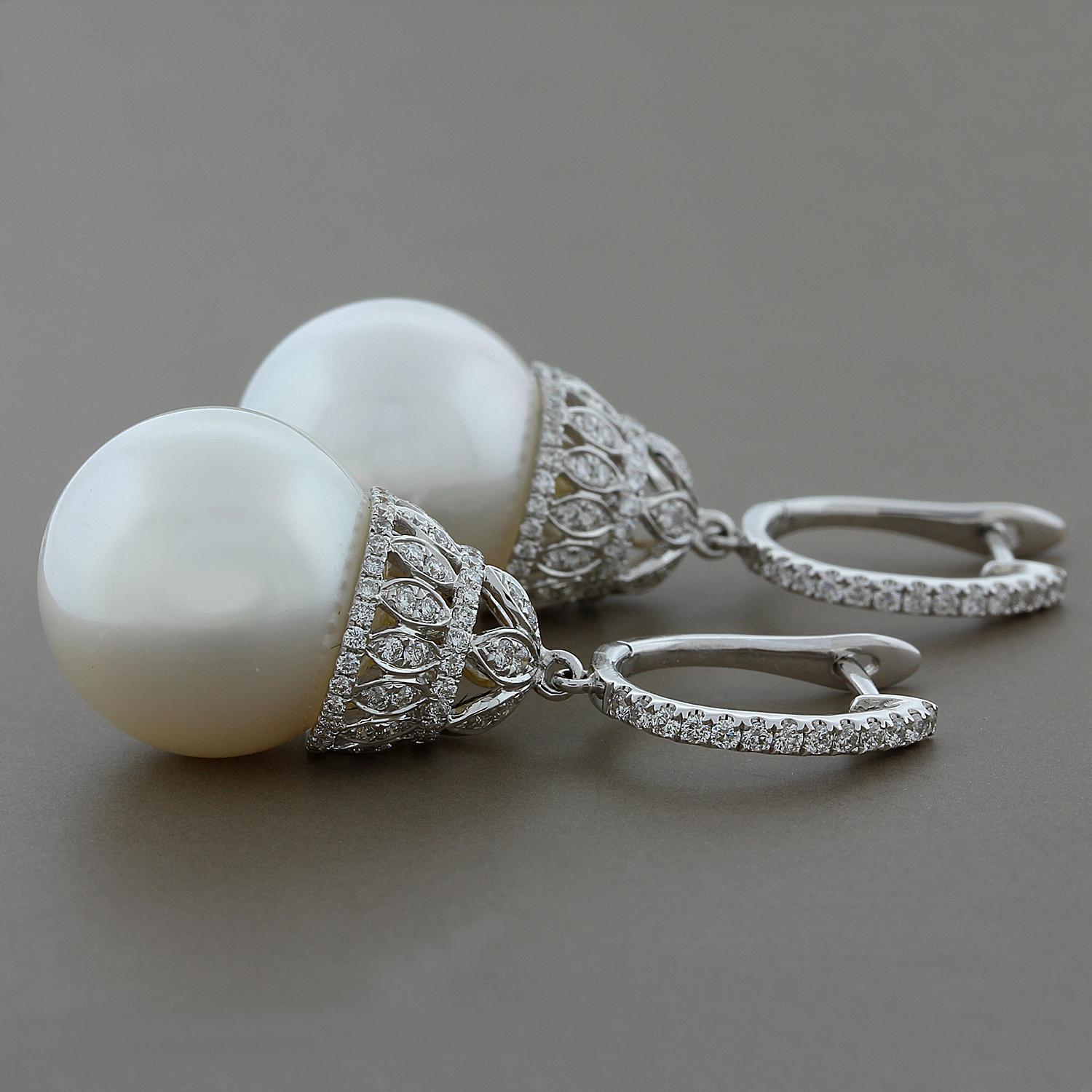 These elegant and feminine drop earrings feature two lustrous 16 mm South Sea pearls hanging from a royal design diamond and 18K white gold basket drop.  A total of 1.00 carat of VS quality diamonds are used. 

Earring Length: 1 5/8 inches
