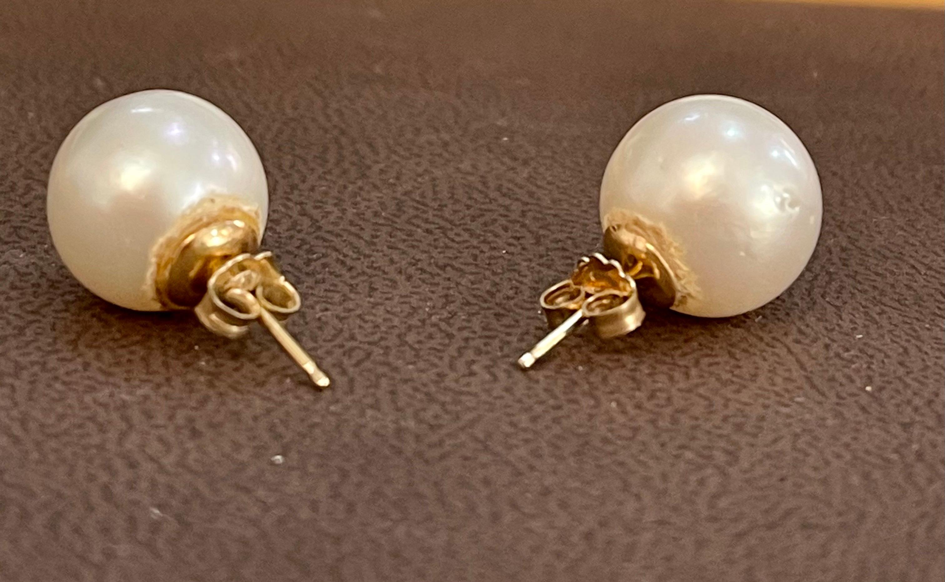 13 MM White South Sea Pearl Stud Earrings 14 Karat Yellow Gold 
 pearls are clean with little bit  blemishes .Approximately 13 mm 
perfect pair made in 14 Karat Yellow gold
backs are made of solid 14 k gold and very sturdy to keep the pearl