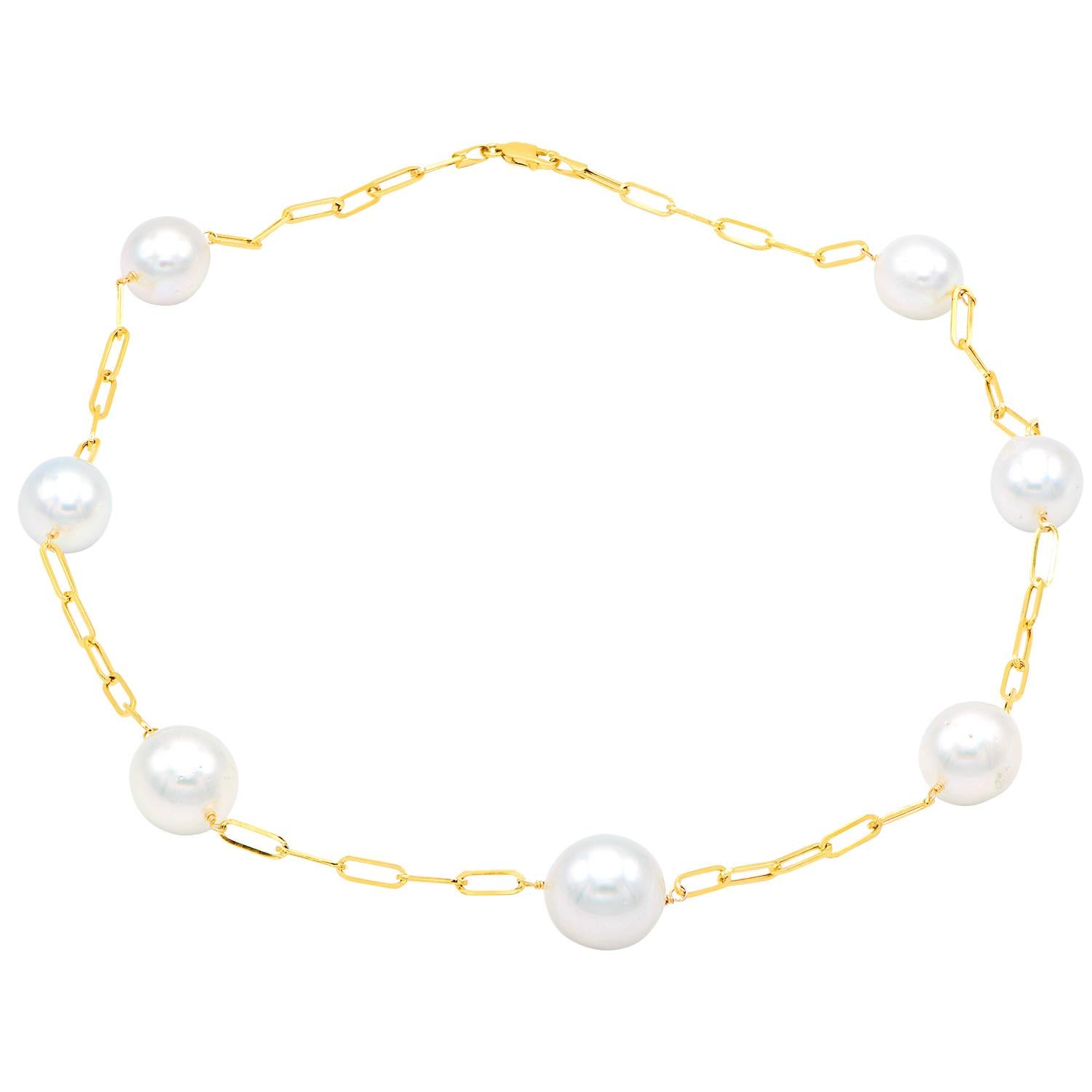 This beautiful necklace is made of 14 karat yellow gold paperclip links with 7, 12-15mm White South Sea pearls throughout. The necklace totals 18 inches long and has AA+ quality pearls. 