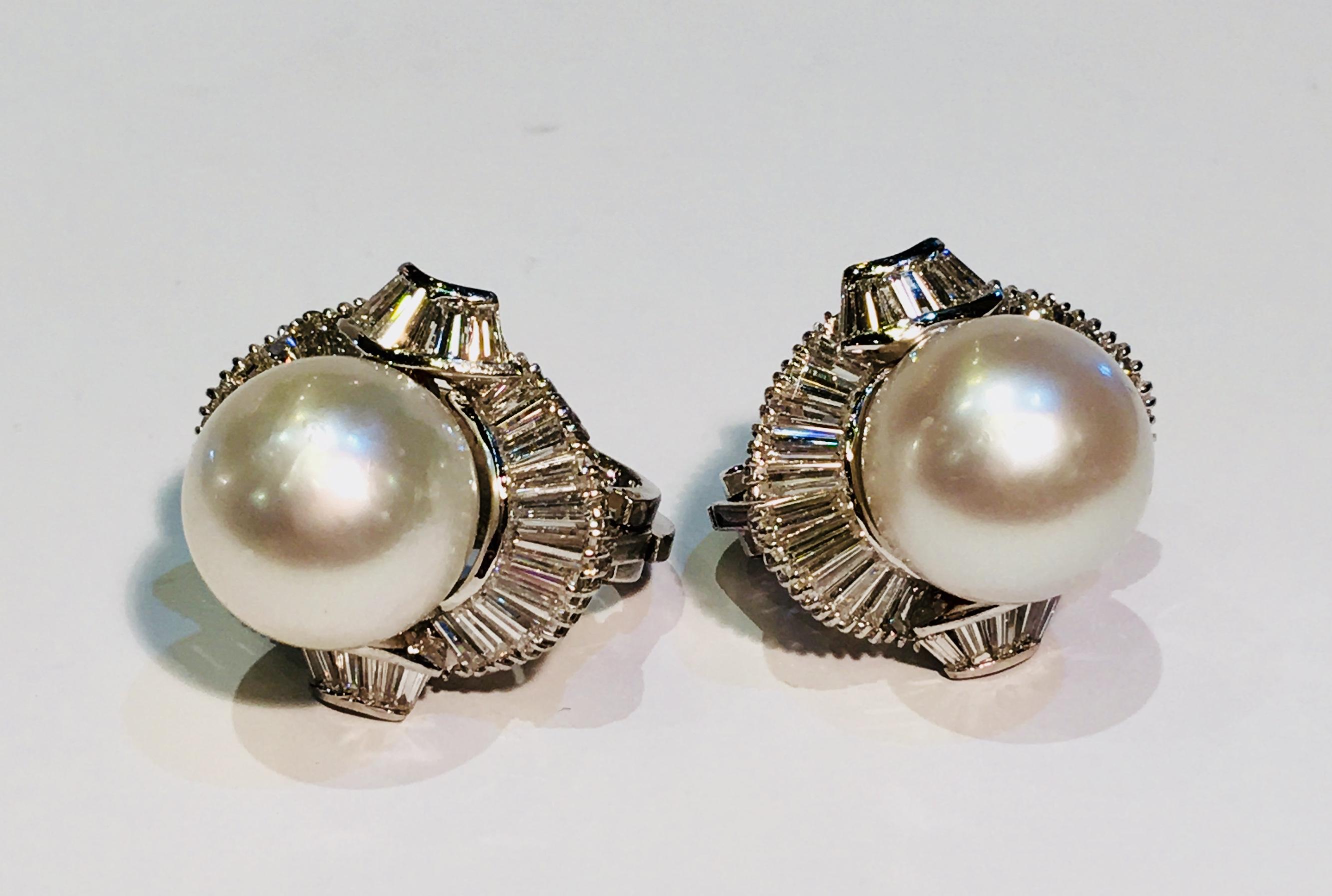 4.5 carats of white diamond baguettes surrounding large round white South Sea pearls, set in 18 karat white gold in these gorgeous, traditional omega back earrings.

Pearls are well matched, measure 12.5 mm each and have a great luster.

30 tapered