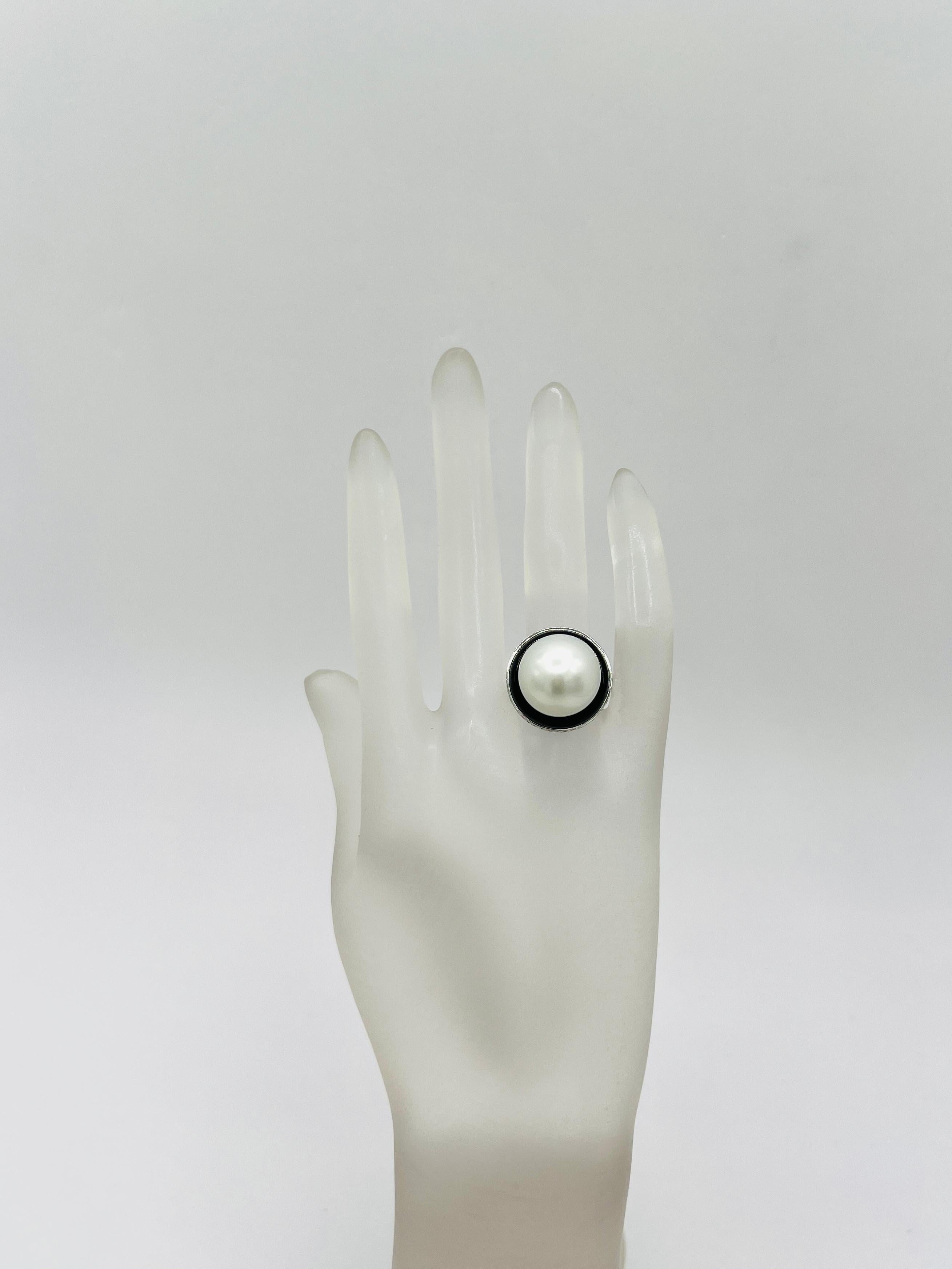 Gorgeous 16.7 mm South Sea round white pearl with 1.16 carats of good quality white diamonds and black onyx in 18k white gold.  South Sea pearl is a beautiful white with no markings.  Ring is size 6.25.  A great addition to any collection! Can be