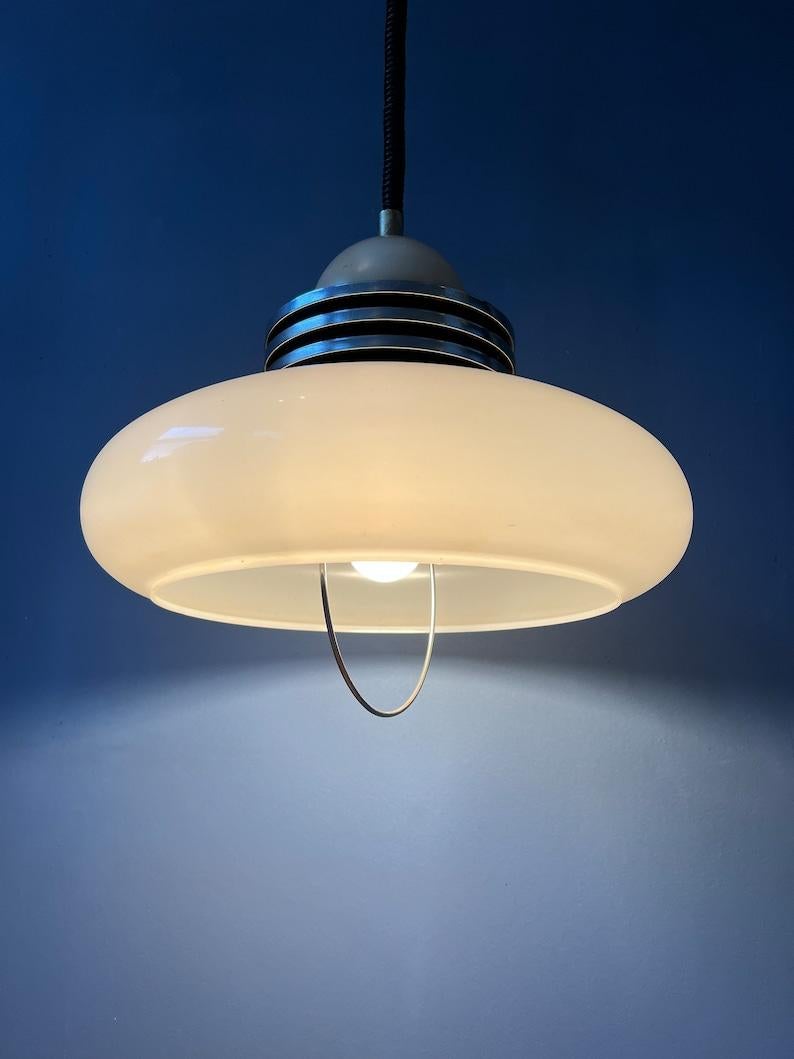 Mid century white space age pendant lamp with acrylic glass shade. The height of the lamp can be adjusted with the rise-and-fall system. The lamp requires one E27 (E26 in the US) lightbulb. The lamp is hardwired for 110v - 230v.

Additional