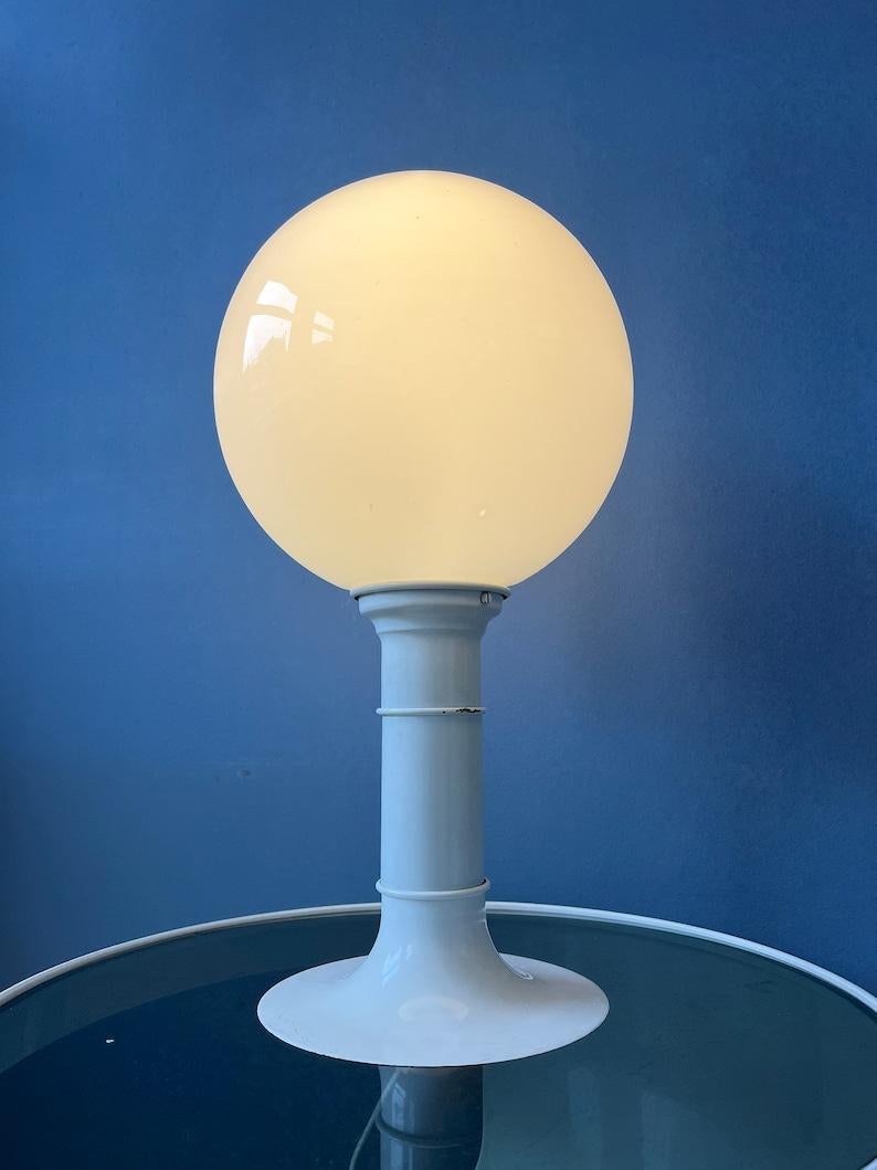 One of a kind large space age table lamp by with opaline glass shade by Woja Holland. The lamp has a metal base with white lacquer. The milk glass shade produces a magnificent light. The lamp requires one E27 lightbulb and currently has an