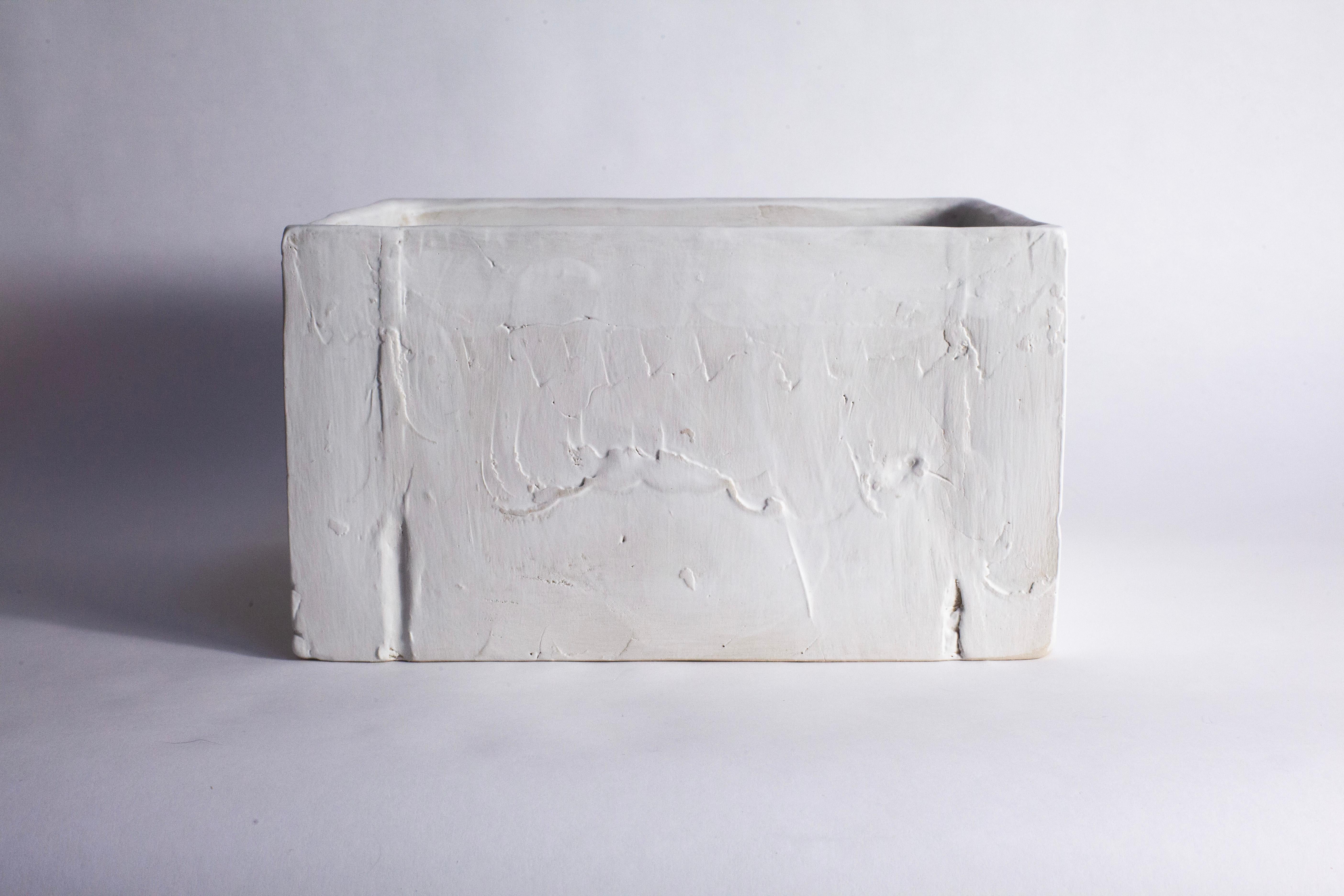 A hand-built, decorative box with a wood-carving -like texture.
Made from smooth, white stoneware and finished with a white, matte, glaze.
The process of building and scraping the material as this box was formed leaves a modelled and physical