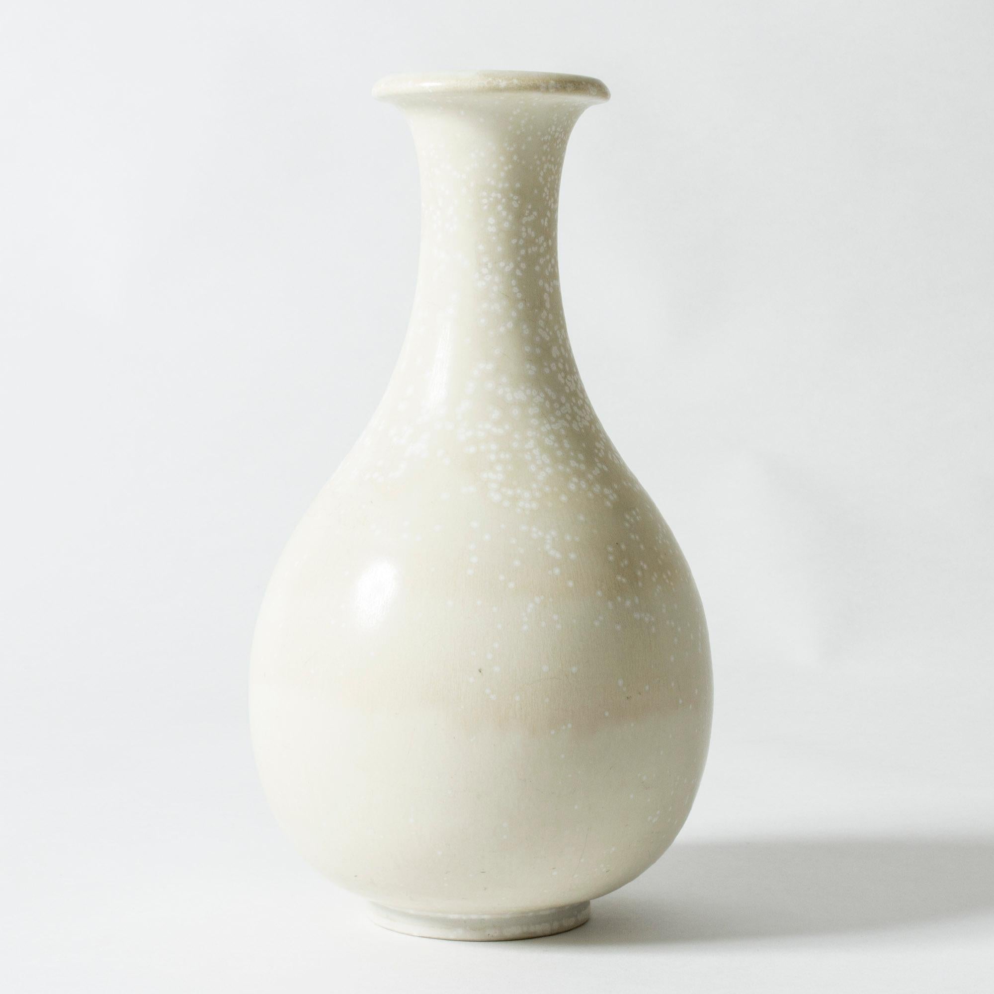 Stoneware vase by Gunnar Nylund, in a beautiful, curvesome form. Glazed eggshell white with a lovely mimosa pattern.

Gunnar Nylund was one of the most influential ceramicists and designers of the Swedish mid-century period. He was Rörstrand’s