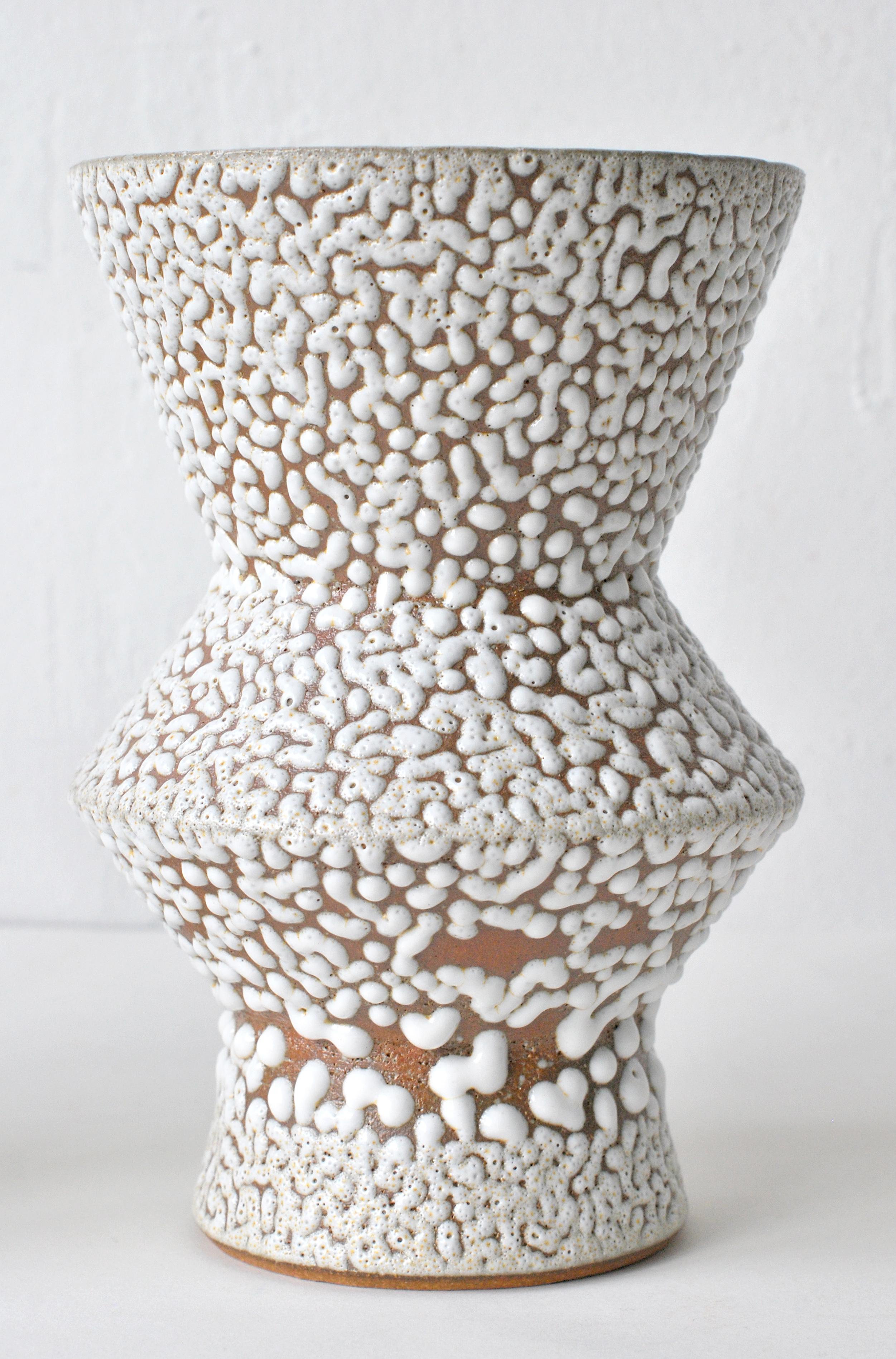 White stoneware vase by Moïo Studio
Dimensions: 17 x 9 x 9 cm
Materials: White crawl glaze on tan stoneware

Is the Berlin-based ceramic art studio of French-Palestinian artist Maia Beyrouti. It was created in 2016 as a result of the desire to