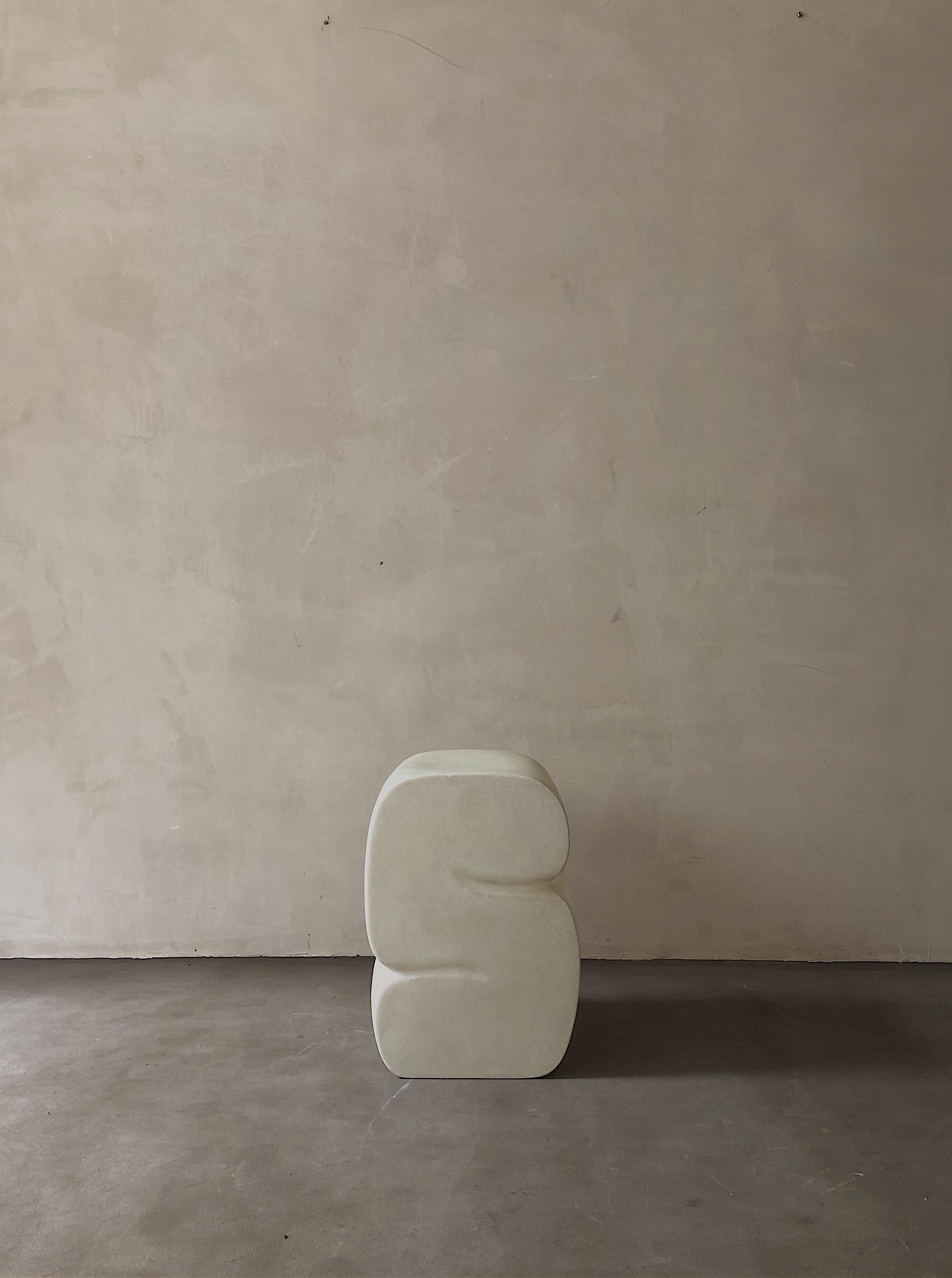White stool by Karstudio.
Materials: FRP.
Dimensions: 32 x 32 x 45 cm.

It shapes in a curl-up position, casual meanwhile restrained. The side designed as a cross-section of the furniture to present the curve and texture.

Kar- is the root of