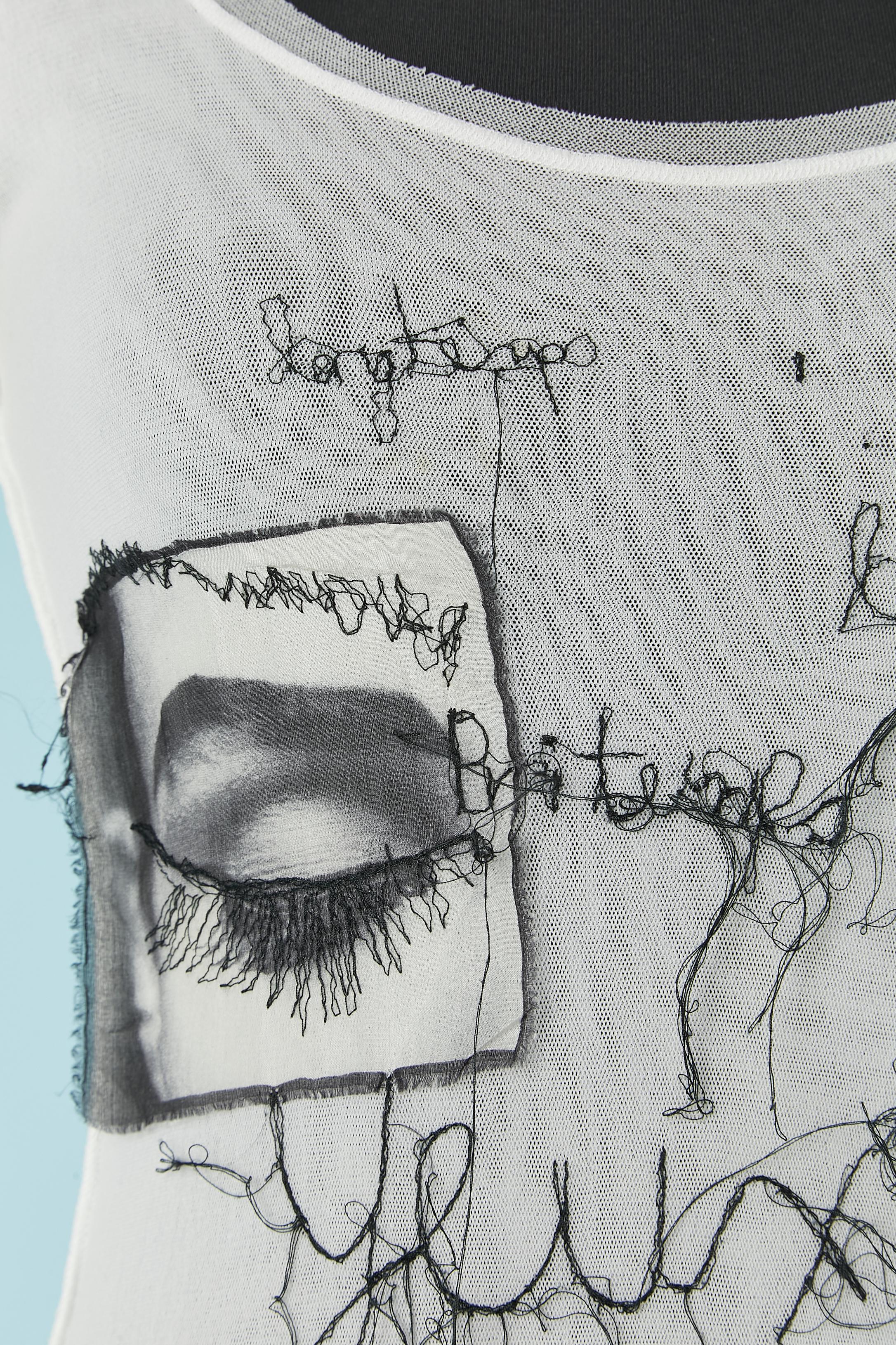 White stretch tulle with black thread words embroideries and 