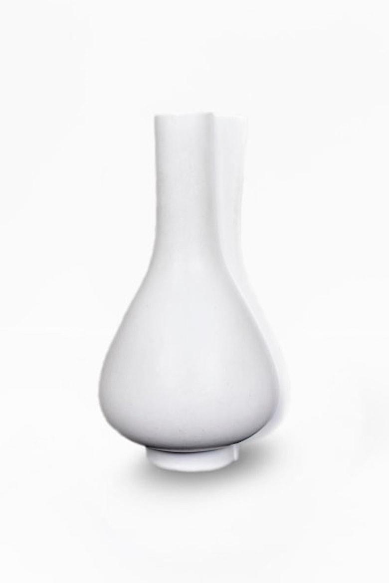 Mid-size white Surrea vase by Wilhelm Kage, Swedish Modernism, 1940s

The Surrea collection is embodied by white, Carrara glazed ceramics that feature offset forms. As the name of the series indicates, the objects are often surrealist, with several