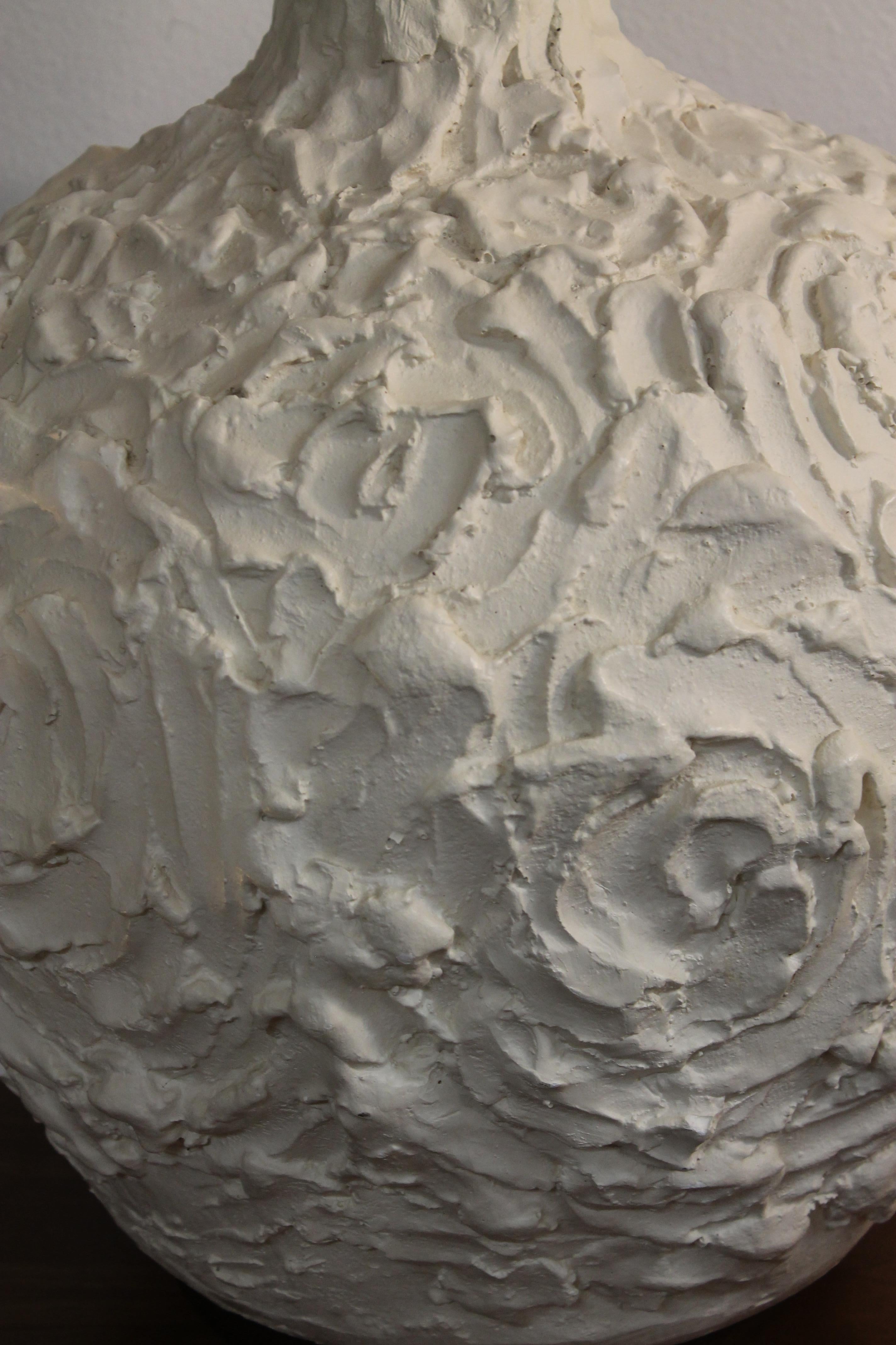 Plaster lamp with swirl patterns throughout.  We describe it as whipped cream. Lamp measures 21.5