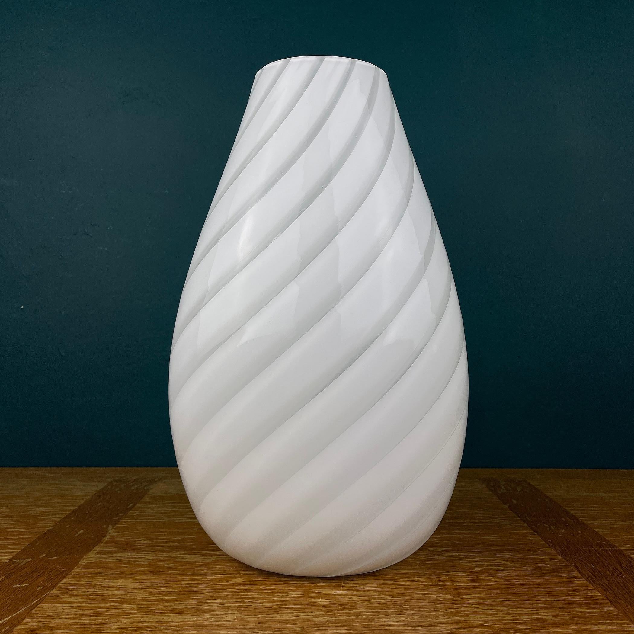 Beautiful white swirl Murano art glass vase made in Italy in the 80s. In very good vintage condition. Mid-century decor for your home. It will definitely become a center in a modern-style living room. Width: 22 centimeters Height: 34 centimeters