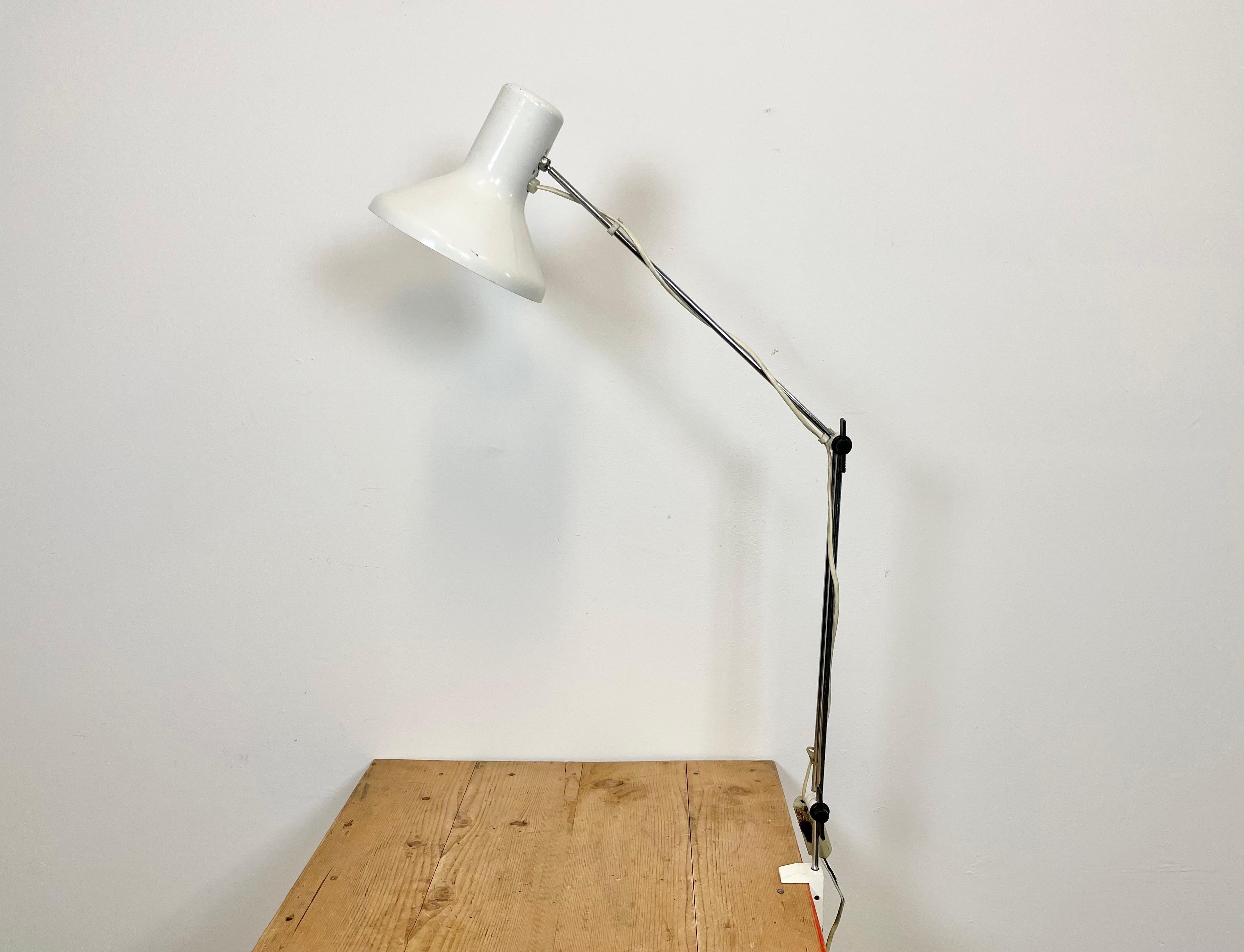 Vintage adjustable table lamp designed by Josef Hurka and produced by Napako in former Czechoslovakia during the 1960s. It features an aluminium shade, a chrome plated arm with two adjustable joints and an iron clamp base. The porcelain socket