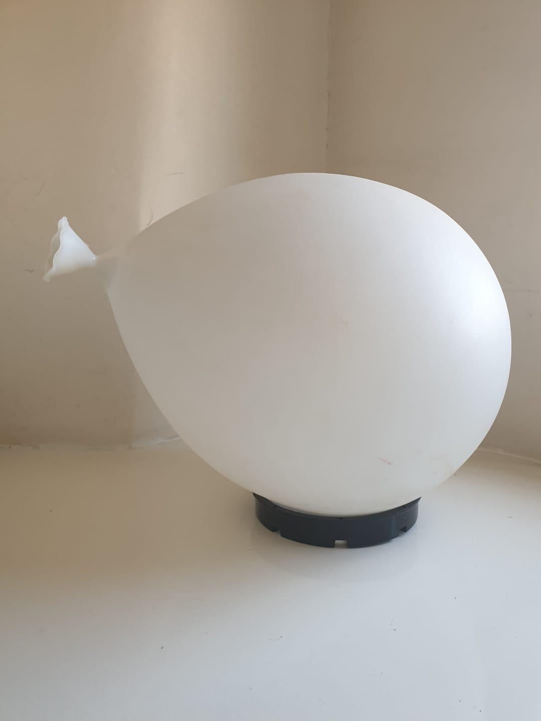 Iconic lamp which can be used as wall, ceiling or table light. When placed on the wall or ceiling it looks like a real floating gas balloon.

Lamp is made of white plastic on a black plastic base. Cord with marble is missing. Lamp is original and