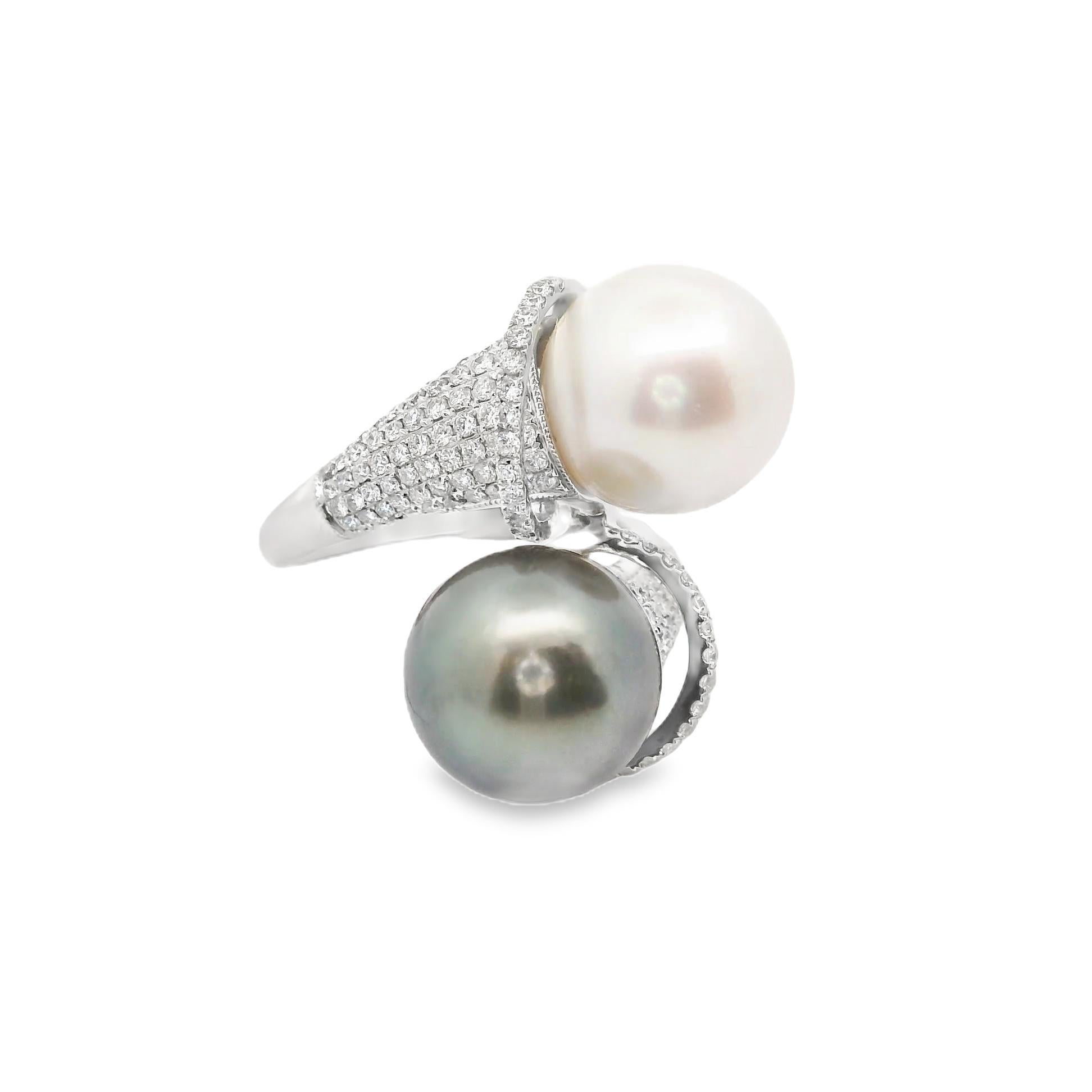 A chic and elegant ring featuring two pearls measuring 11.3mm each. They are perfectly rounded, matching in size, with one having a white body color while the other has a Tahitian pistachio color. They are complemented by 0.85 carats of round