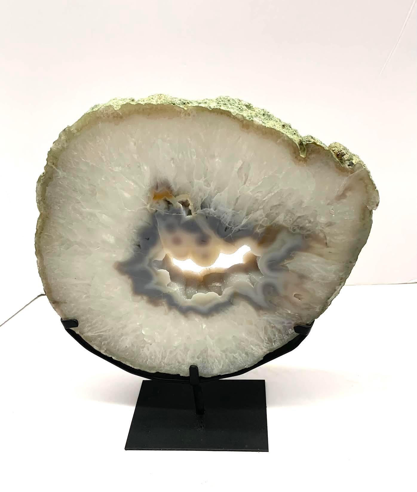 Prehistoric Brazilian thick agate geode on stand.
Center hole reveals beautiful natural silver crystals.
Stand measures 6