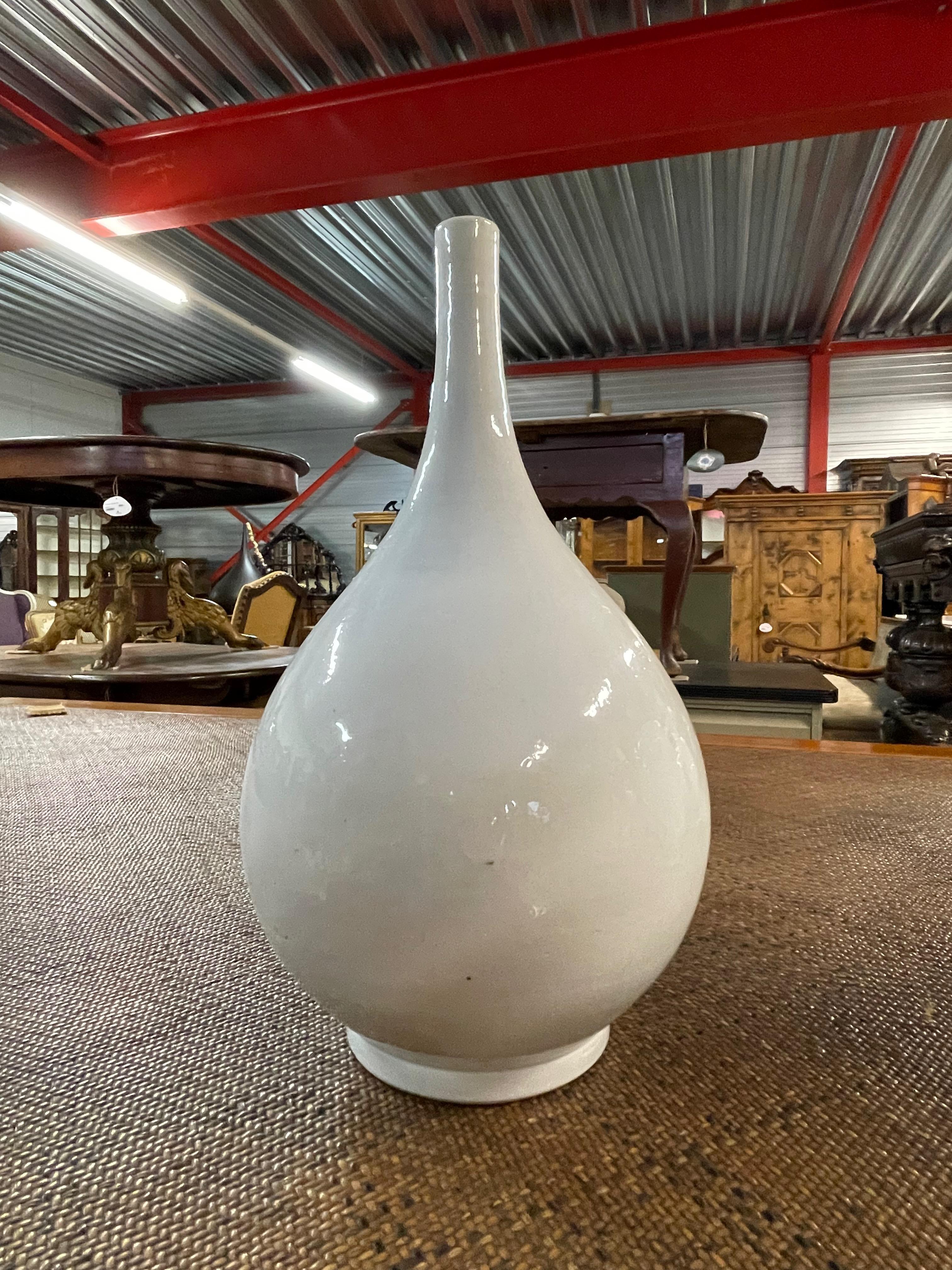 Contemporary Chinese white long thin neck spout vase.
Two available and sold individually.
From a large collection of white vases in different sizes and shapes.