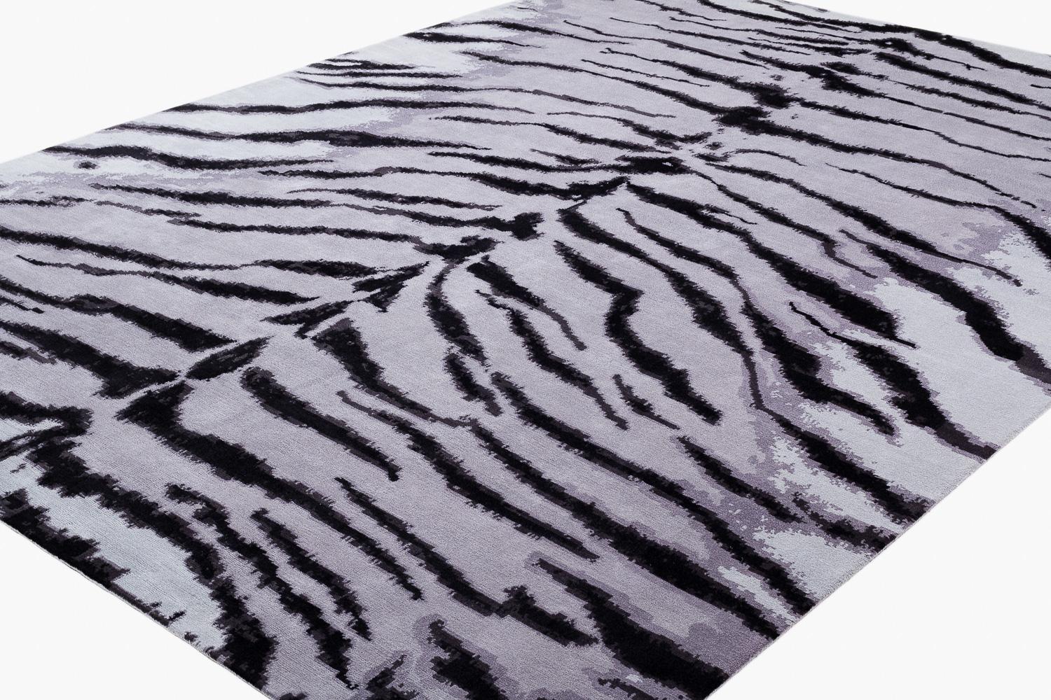 A Carini Classic, this White Tiger luxurious area rug is exudes power and fashion. Designed by Joseph Carini, this has been a mainstay in his collection for over 20 years. Shown here in a custom and unique colorway, the silver and grey tones form a