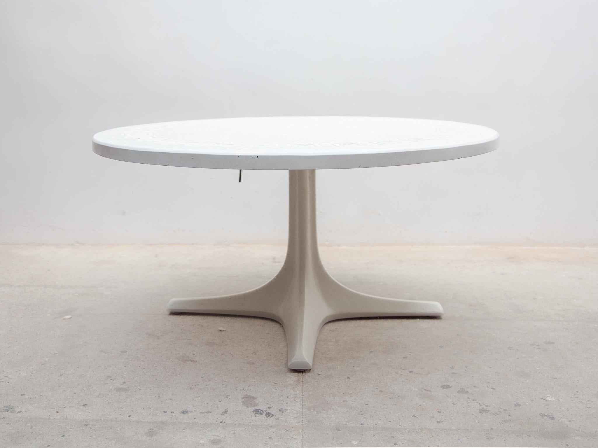 Coffee table from Ilse Möbel, Germany. Height adjustable coffee table up to a dining table. Beautiful round top table with a meander motif in bakelite and white coated at a metal adjustable base. Labeled by Ilse Mobel, Germany 1960s.