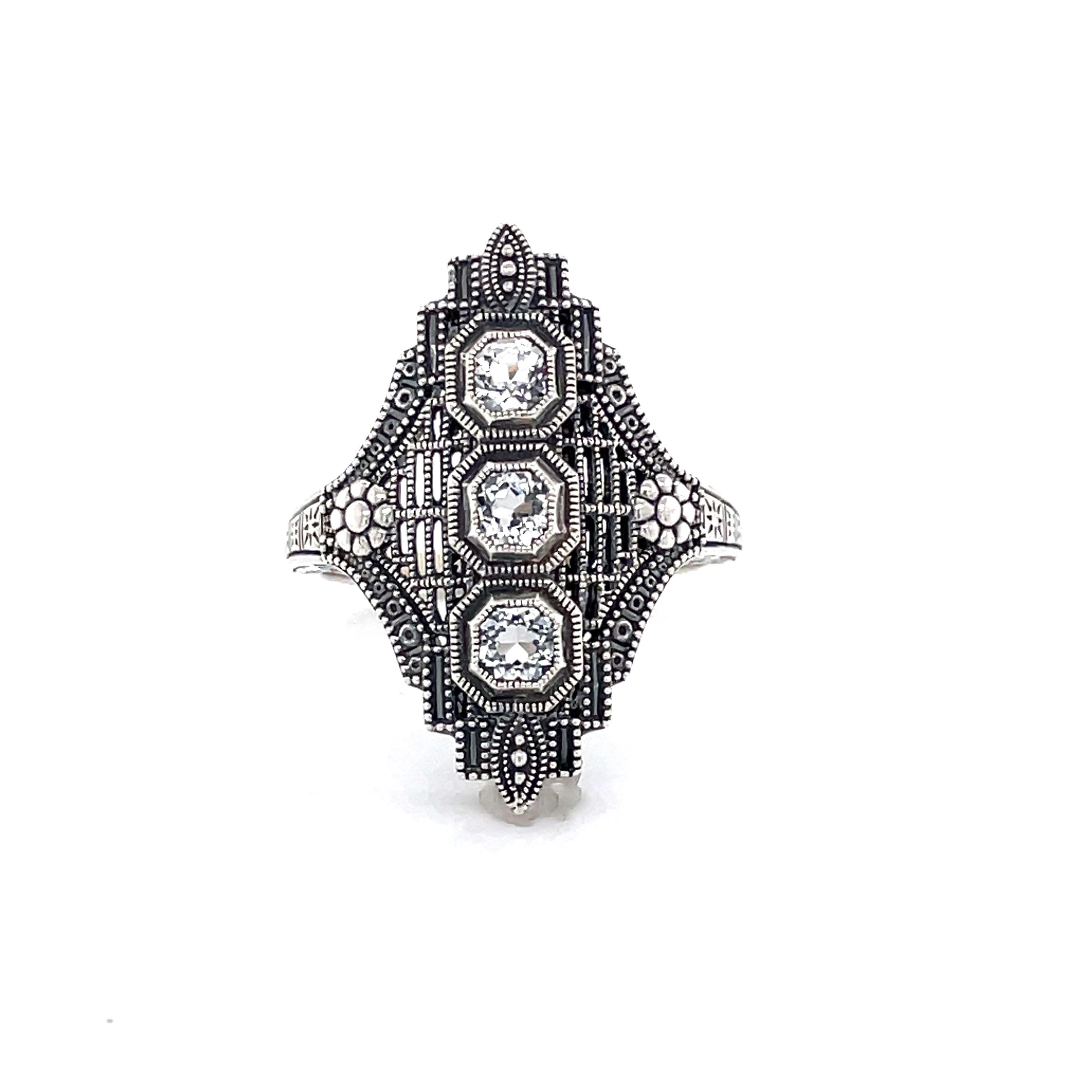 Vintage inspired ornate filigree design in sterling silver with exquisite details in the style of the Art Deco Period. Three .20 carat cushion cut white topaz,
 .60 carats TW, are aligned and centered for a bold look. Presented in a miniature