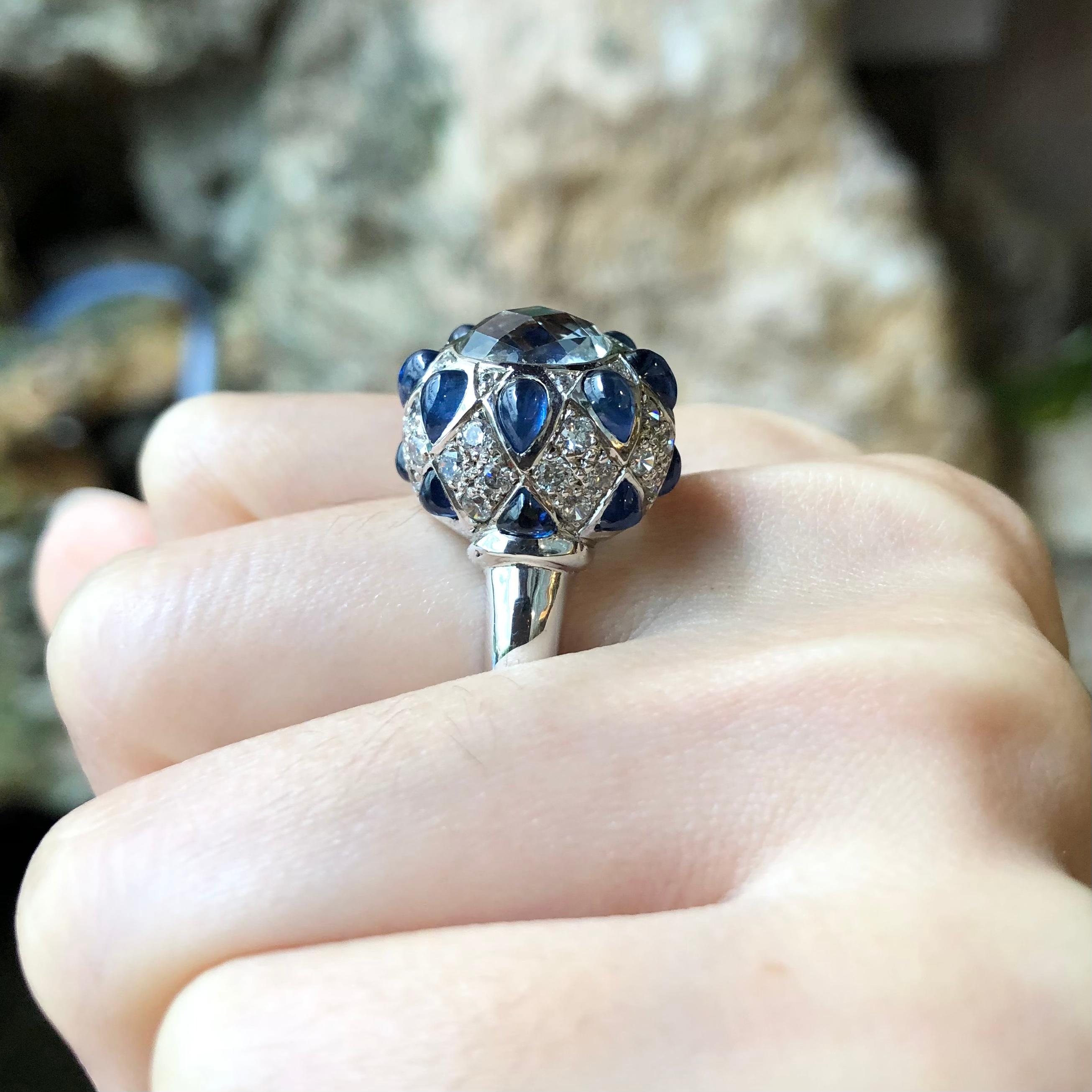 White Topaz, Cabochon Blue Sapphire with Cubic Zirconia Ring set in Silver Settings

Width:  1.7 cm 
Length: 1.7 cm
Ring Size: 58
Total Weight: 8.98 grams

*Please note that the silver setting is plated with rhodium to promote shine and help prevent