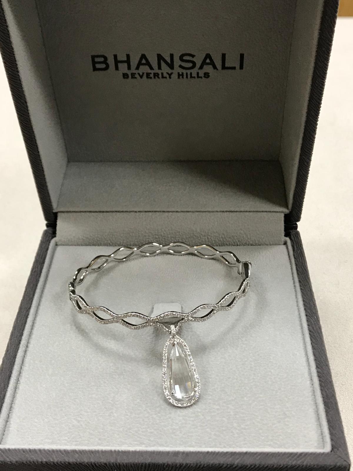 From the Bhansali LIGHT Collection, this unique cocktail bangle is set in 18kt White Gold with Round Brilliant-Cut Diamonds and a Divine Cut White Topaz. The divine cut is unique to Bhansali and was inspired by the Indian bindi, a physical symbol of