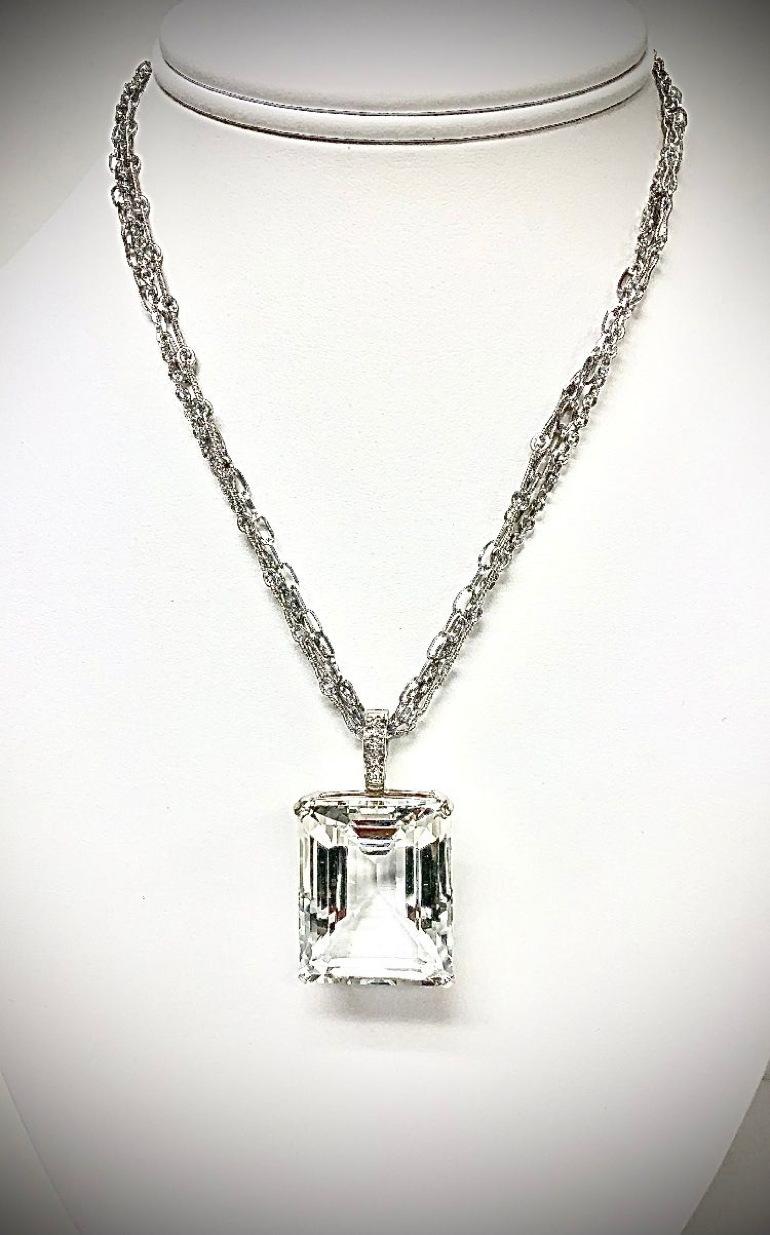 Description
Impressive, large flawless 80 carat Natural White Topaz pendant suspended from a 14k white gold triple chain necklace. Pendant is removable, but not sold separately.
Item # N3831

Materials and Weight
White topaz, 29 x 23mm, emerald cut,