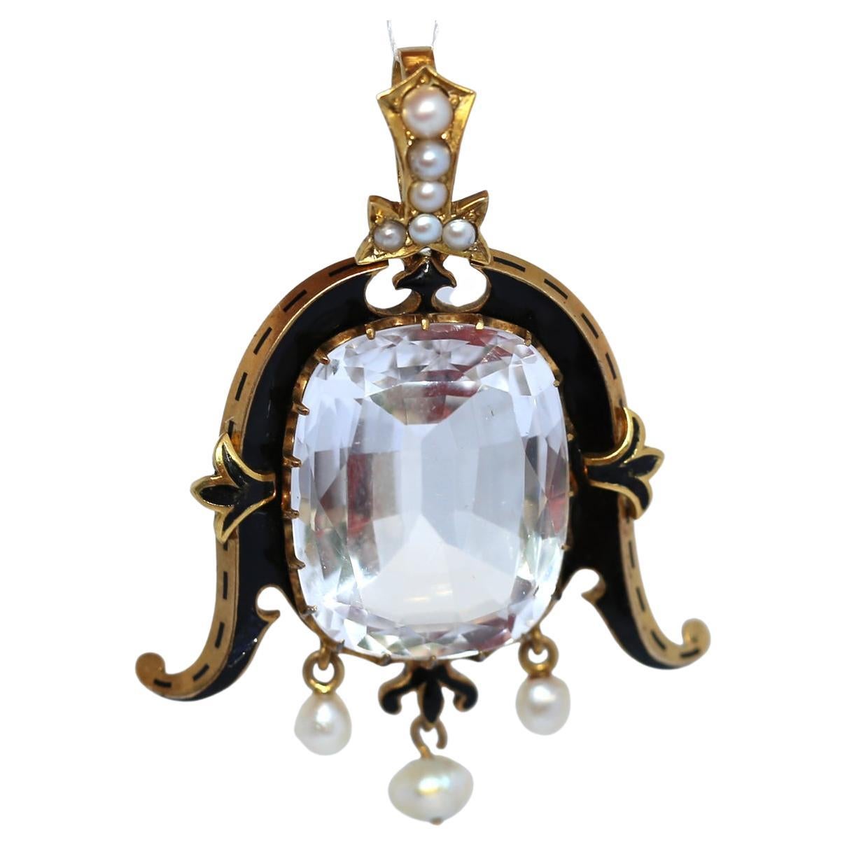 Antique White Topaz, Pearl & Enamel Pendant in Yellow Gold, c.1890

Overview
A striking late 19th-century pendant crafted in yellow gold and set with a large white topaz, pearls, and black enamel accents. Created around 1890, this jewel combines