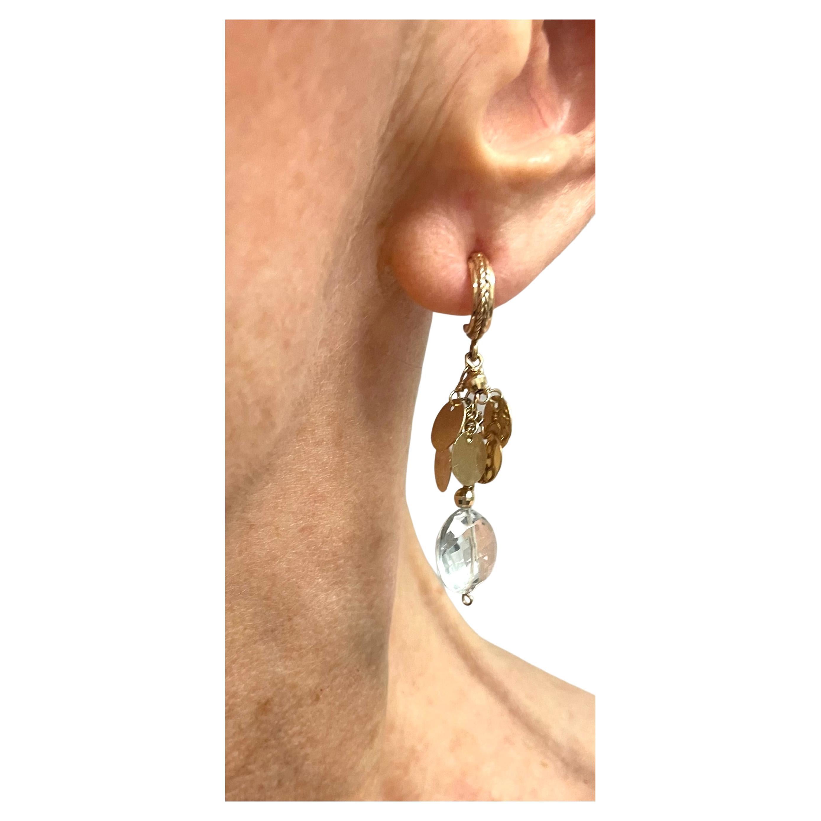 Description
These charming and feminine earrings are styled with 14k yellow gold discs and faceted balls which accentuates the beauty of the White Topaz dangling stones. The discs reflect light as they move creating an eye catching effect.
Item #