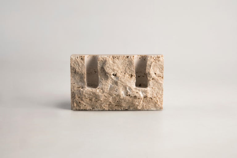 White travertine sculpted candleholder by Sanna Völker
The size of the candleholder is 15 x 3 x 9 cm, designed to be used with drip-less candles of size Ø22 mm. 

All pieces are handcrafted in natural stone. This results in variations in color
