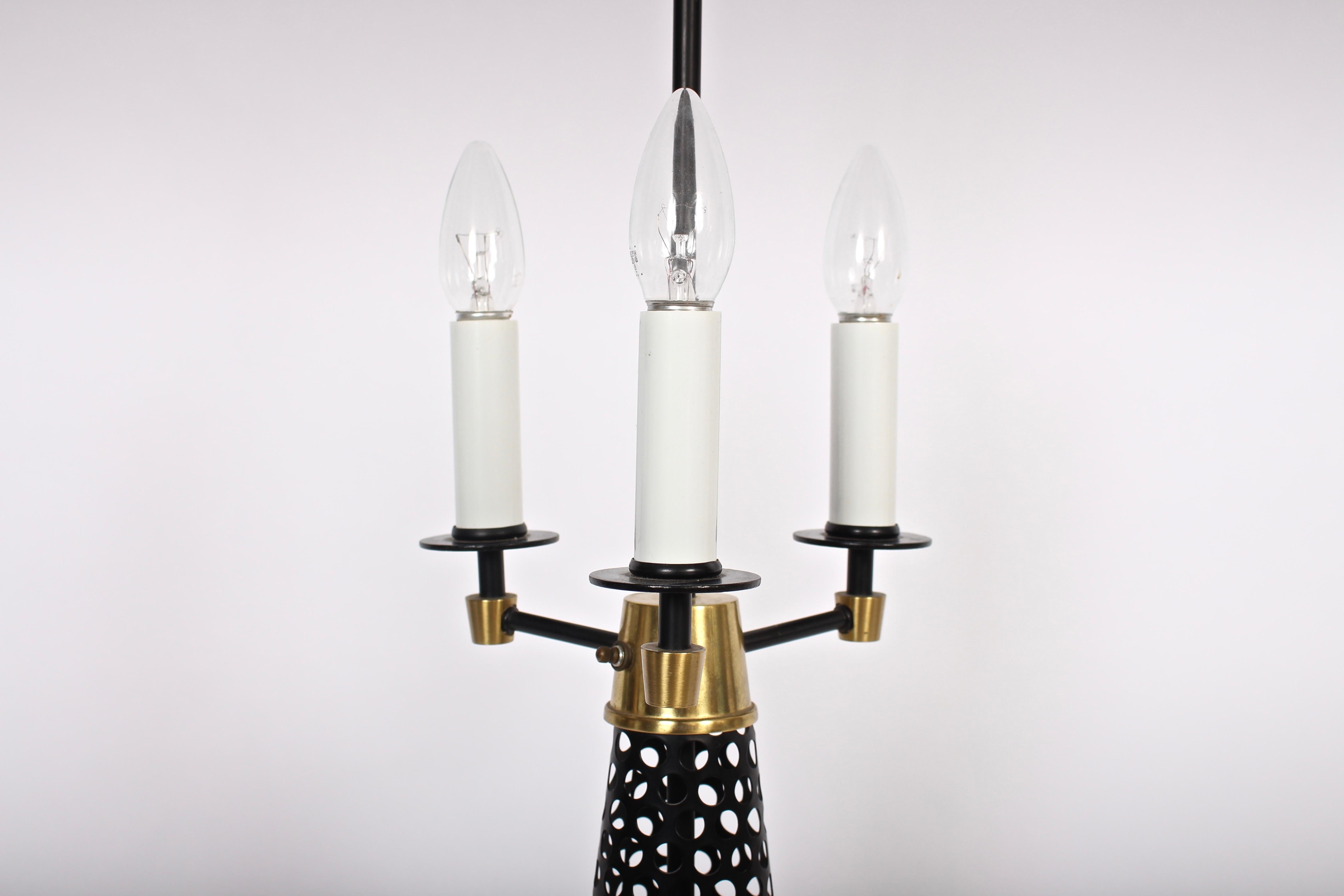 Mid-20th Century Tony Paul Style Pierced Black Cone, Brass Triple White Candlestick Table Lamp For Sale