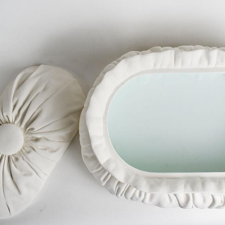 A lovely Trompe L'Oeil unglazed taureen. This beautiful piece is oval in shape and resembles an upholstered draped pillow box. It is created of plaster and made to look like tufts of draped fabric. At the top, a lid fits snuggly within its scalloped